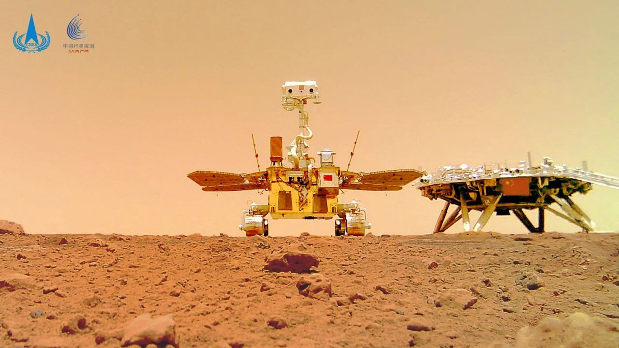 China’s Mars rover Zhu Rong is pictured next to the landing platform with a Chinese national flag on it, taken by a remote camera on Mars in June 2021. Photo: EPA-EFE/China National Space Administration