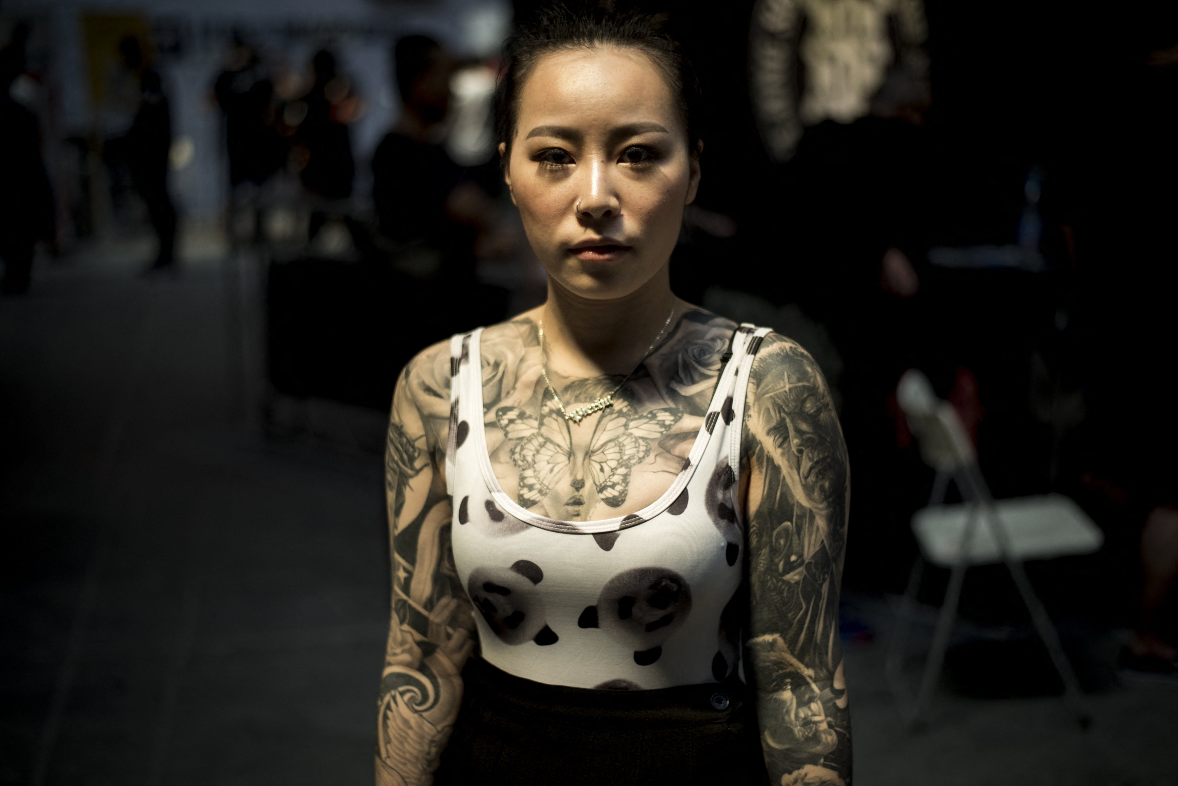 A woman poses with tattoos at the Langfang International Tattoo show, in Hebei province, central China in 2016. Photo: AFP