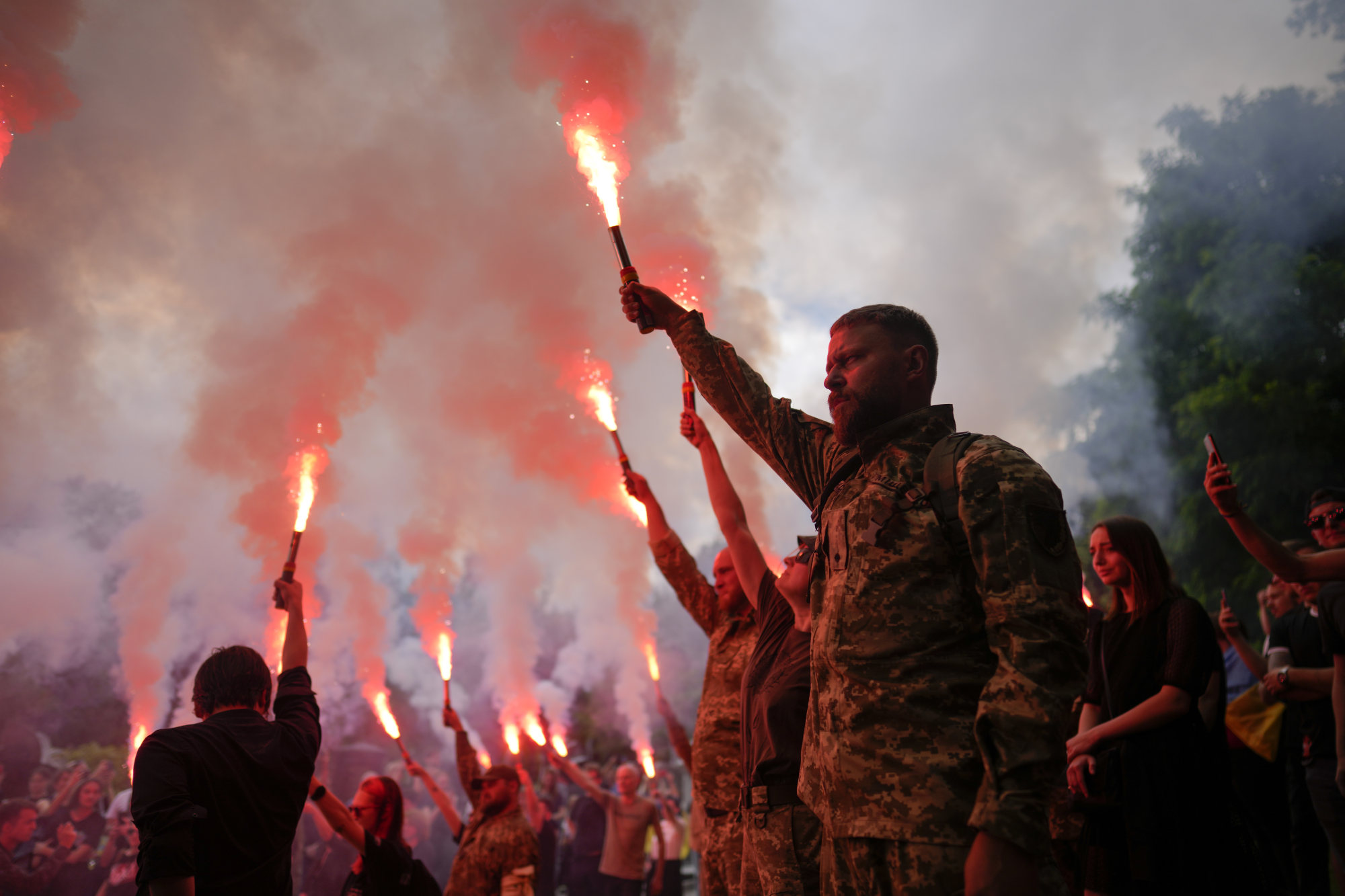 Soldiers hold flares as they attend the funeral on Saturday in Kyiv, Ukraine, of activist Roman Ratushnyi, who died fighting for the Ukrainian army against Russian intruders. The Russian military’s biggest mistake has been to underestimate its enemy. Photo: AP