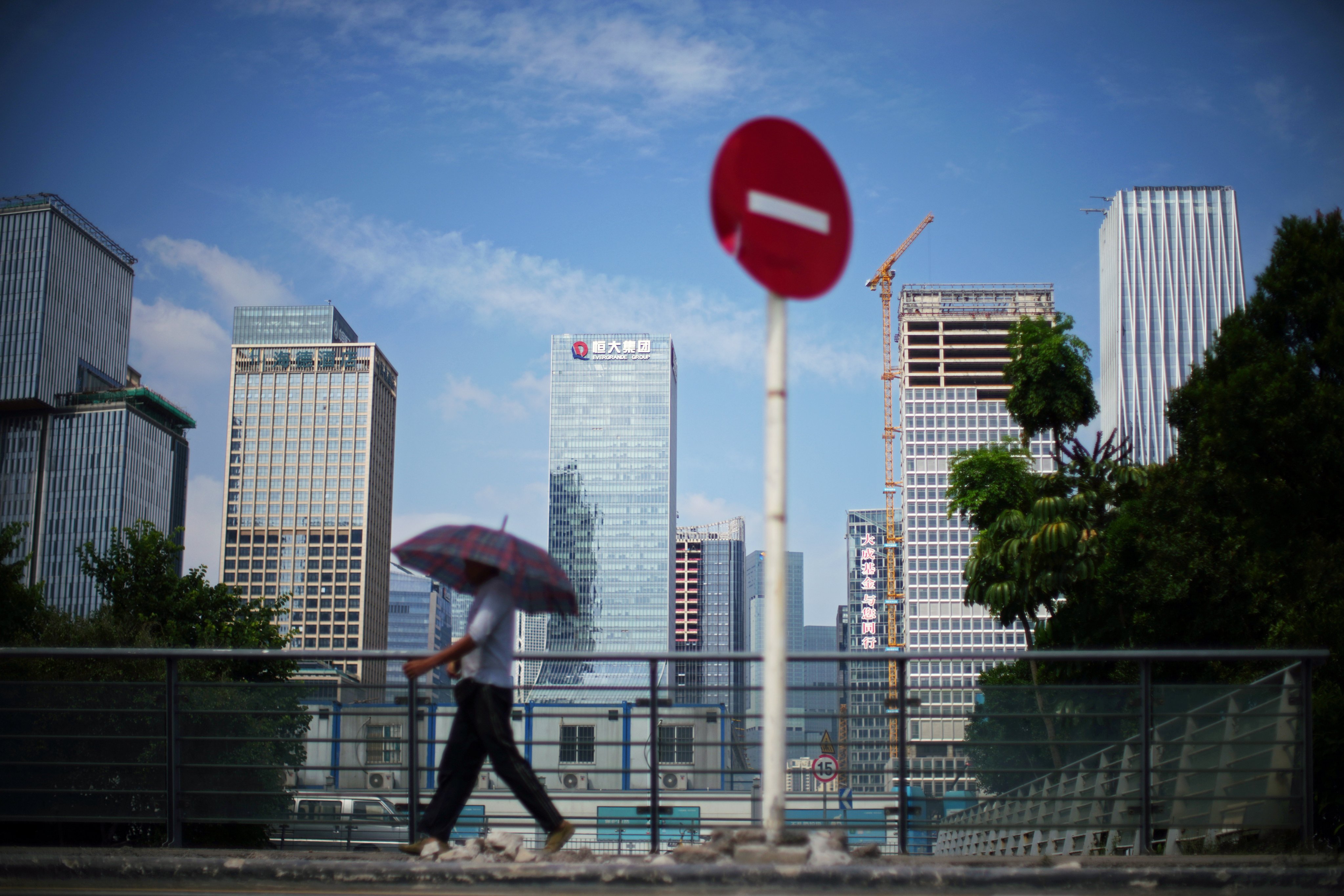 A man walks past a No Entry traffic sign near the headquarters of China Evergrande Group in Shenzhen, on September 26, 2021. Photo: Reuters