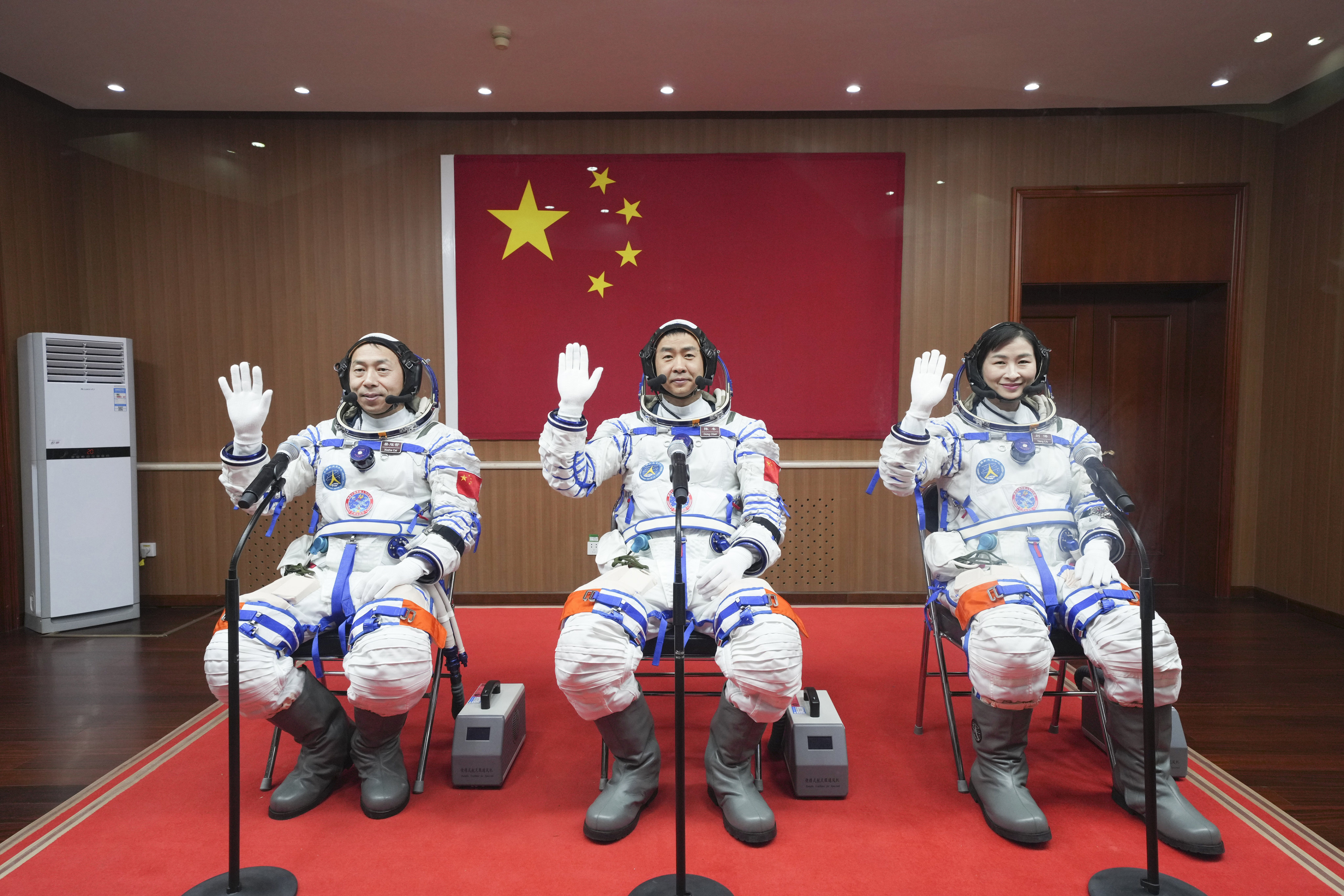 Chinese astronauts Cai Xuzhe, Chen Dong and Liu Yang wave before a send-off ceremony for the Shenzhou-14 crewed space mission, at the Jiuquan Satellite Launch Centre in northwestern China, on June 5. Photo: Xinhua 