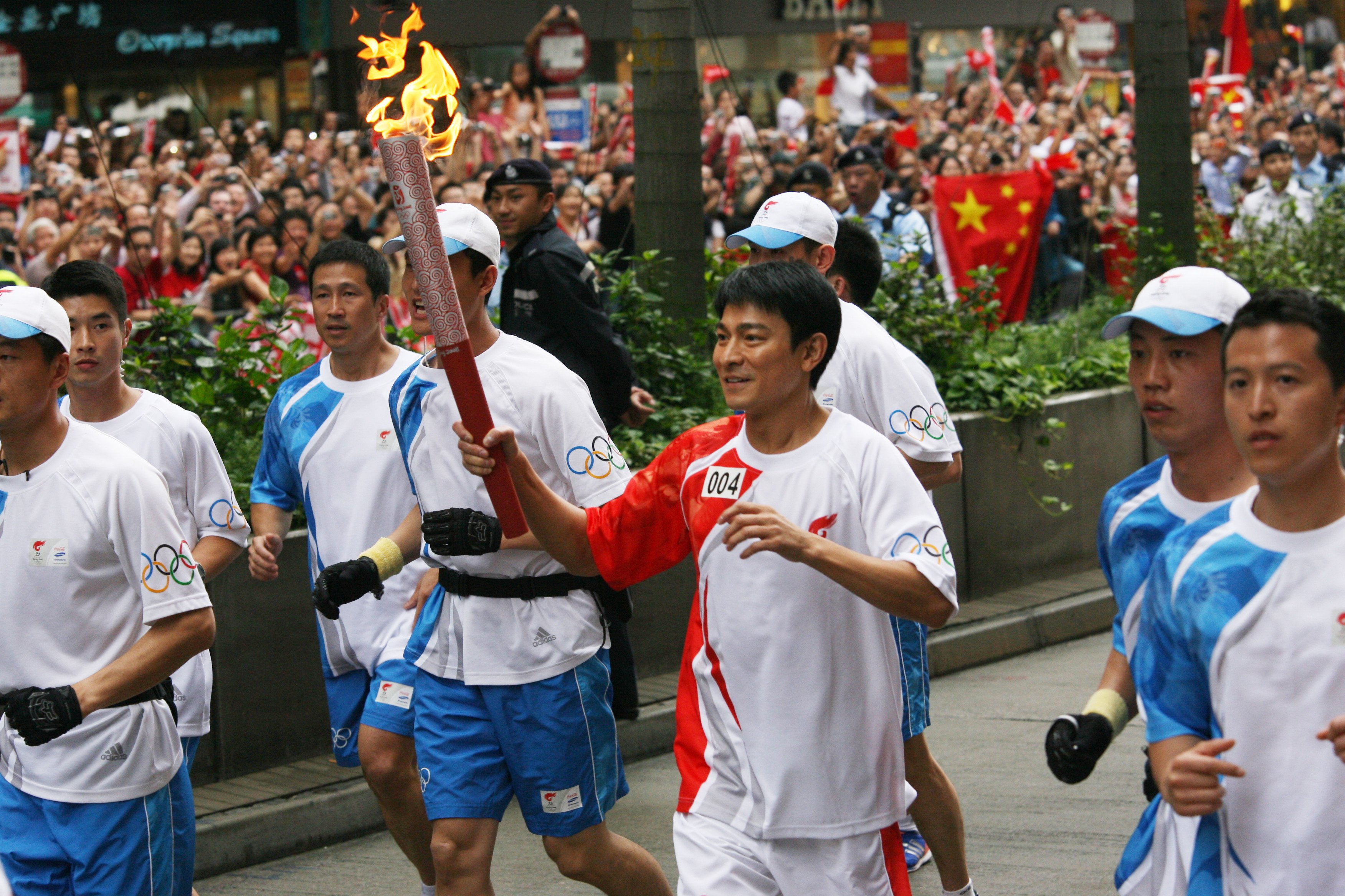Canto-pop superstar Andy Lau carries the Olympic torch through Tsim Sha Tsui on May 2, 2008. Photo: Oliver Tsang