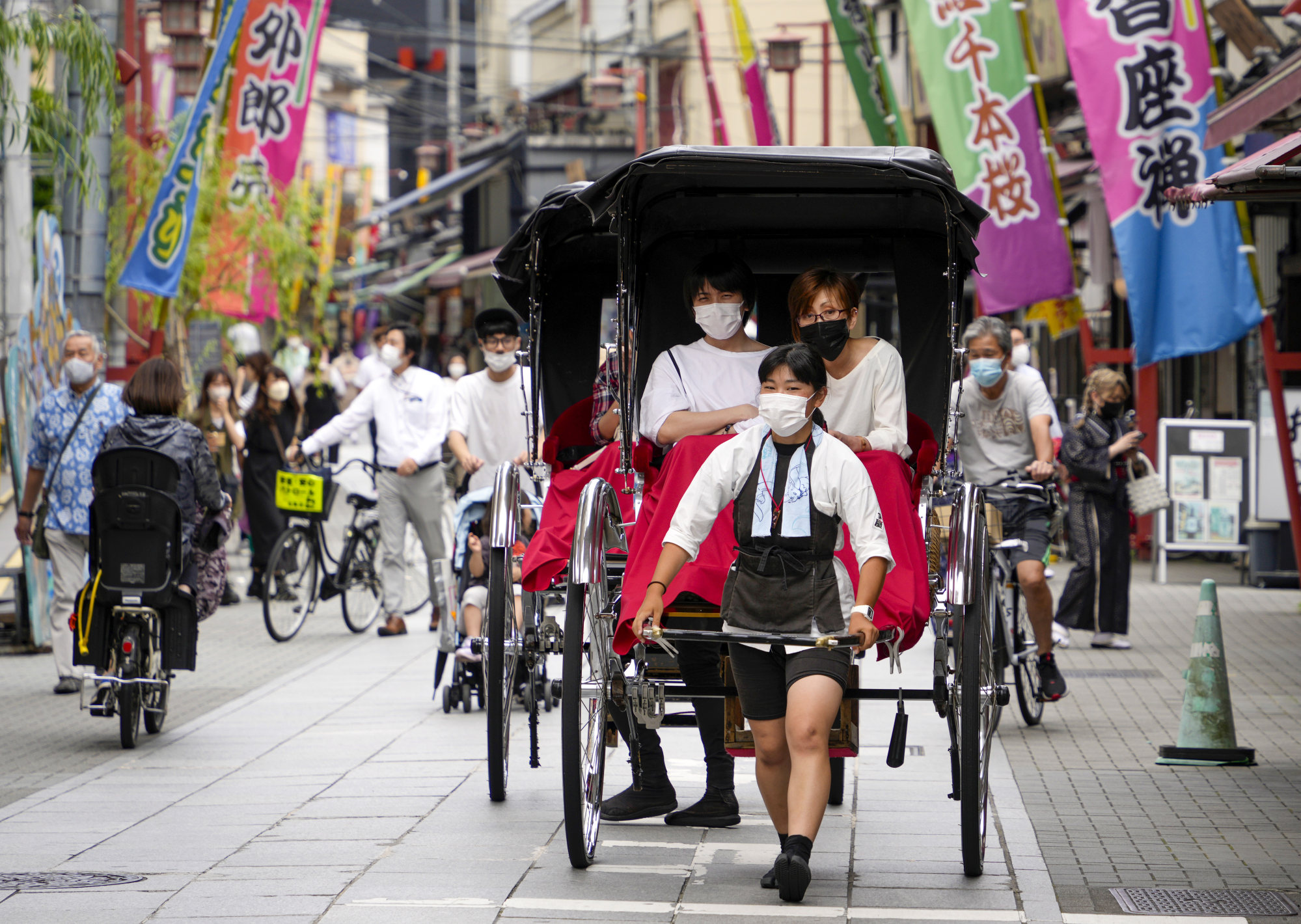 Tourists enjoy a rickshaw ride in Tokyo’s Asakusa district after Japan eased it Covid-19 rules this month. Photo: EPA-EFE