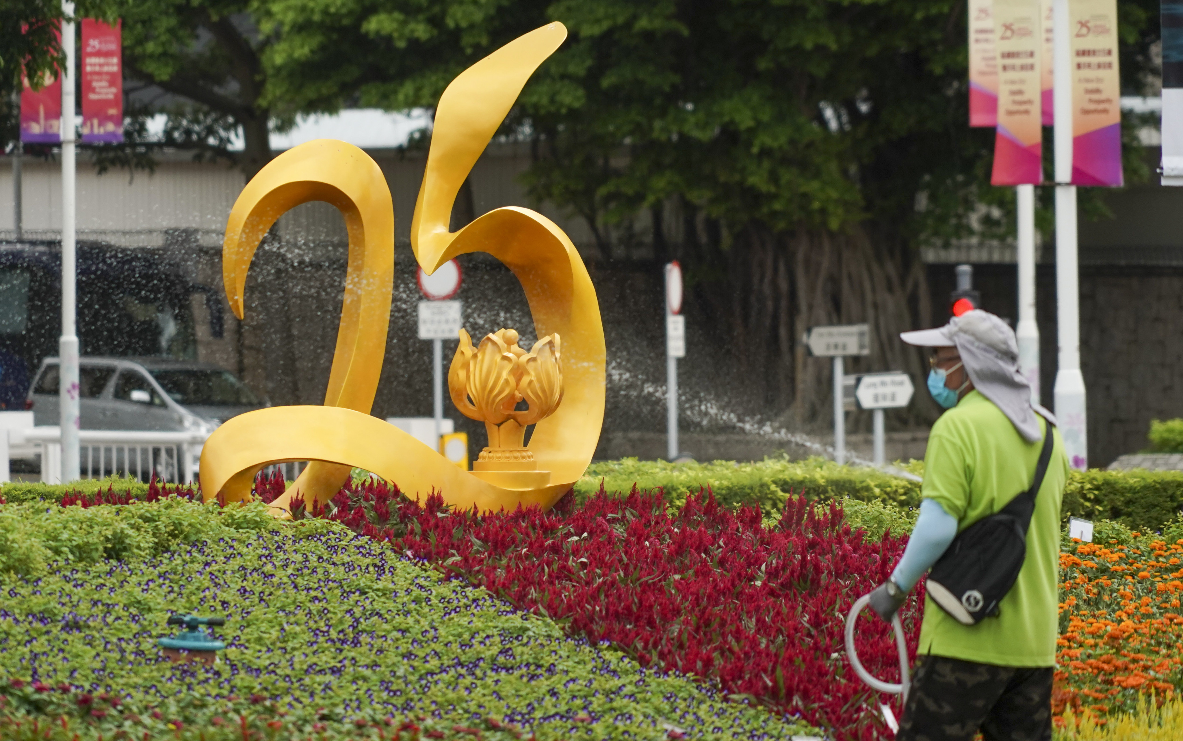A worker waters plants at a new installation at Tamar Park, “Art@Harbour”, to celebrate the 25th anniversary of the establishment of the Hong Kong special administrative region. Photo: Felix Wong