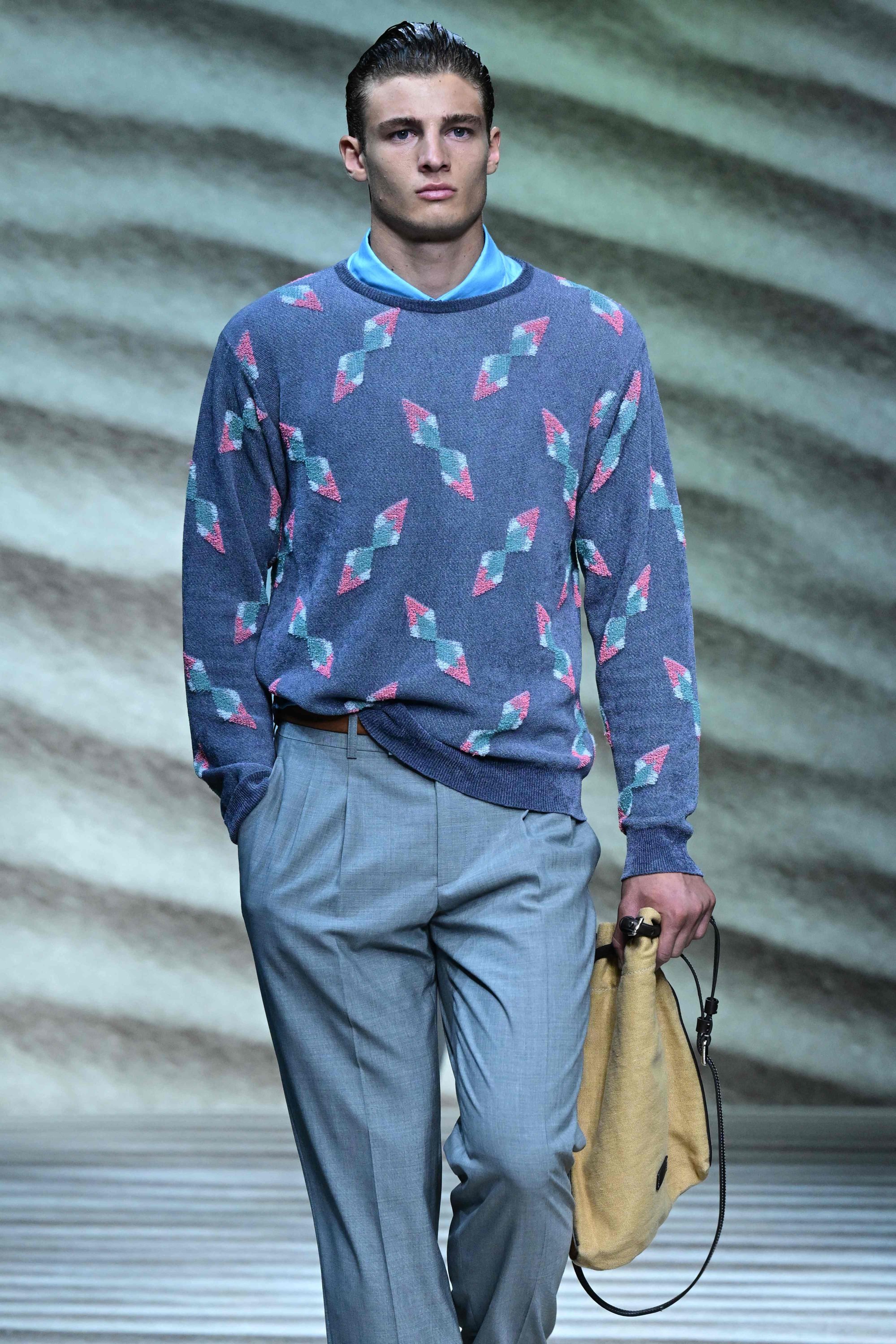 Man with black Moncler padded jacket, yellow trousers and blue Louis Vuitton  bag before Giorgio Armani fashion show, Milan Fashion Week street style on  January 15, 2018 in Milan. – Stock Editorial