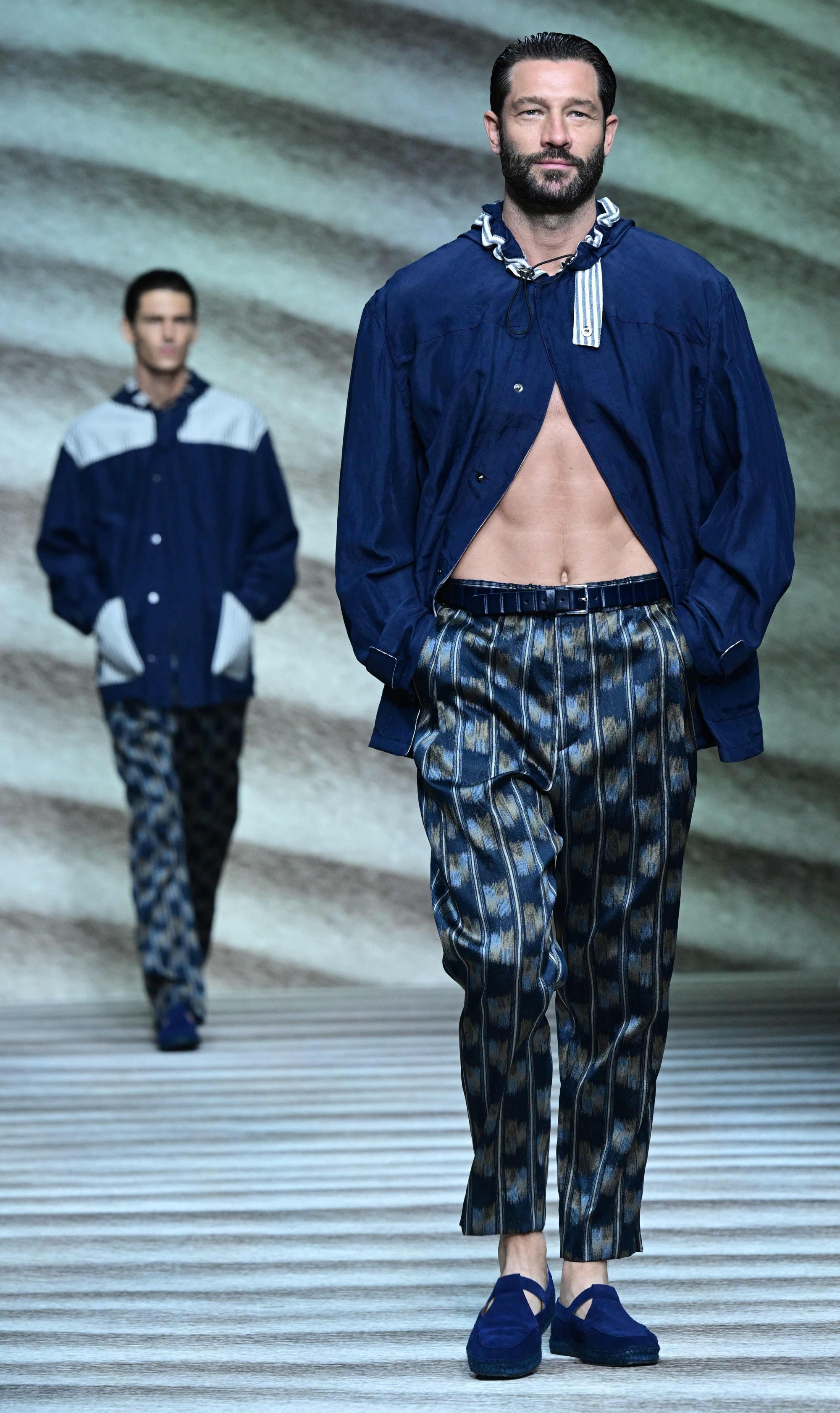 A model wears an open shirt at Giorgio Armani’s men’s spring/summer 2023 fashion collection show on June 20, in Milan. Photo: AFP