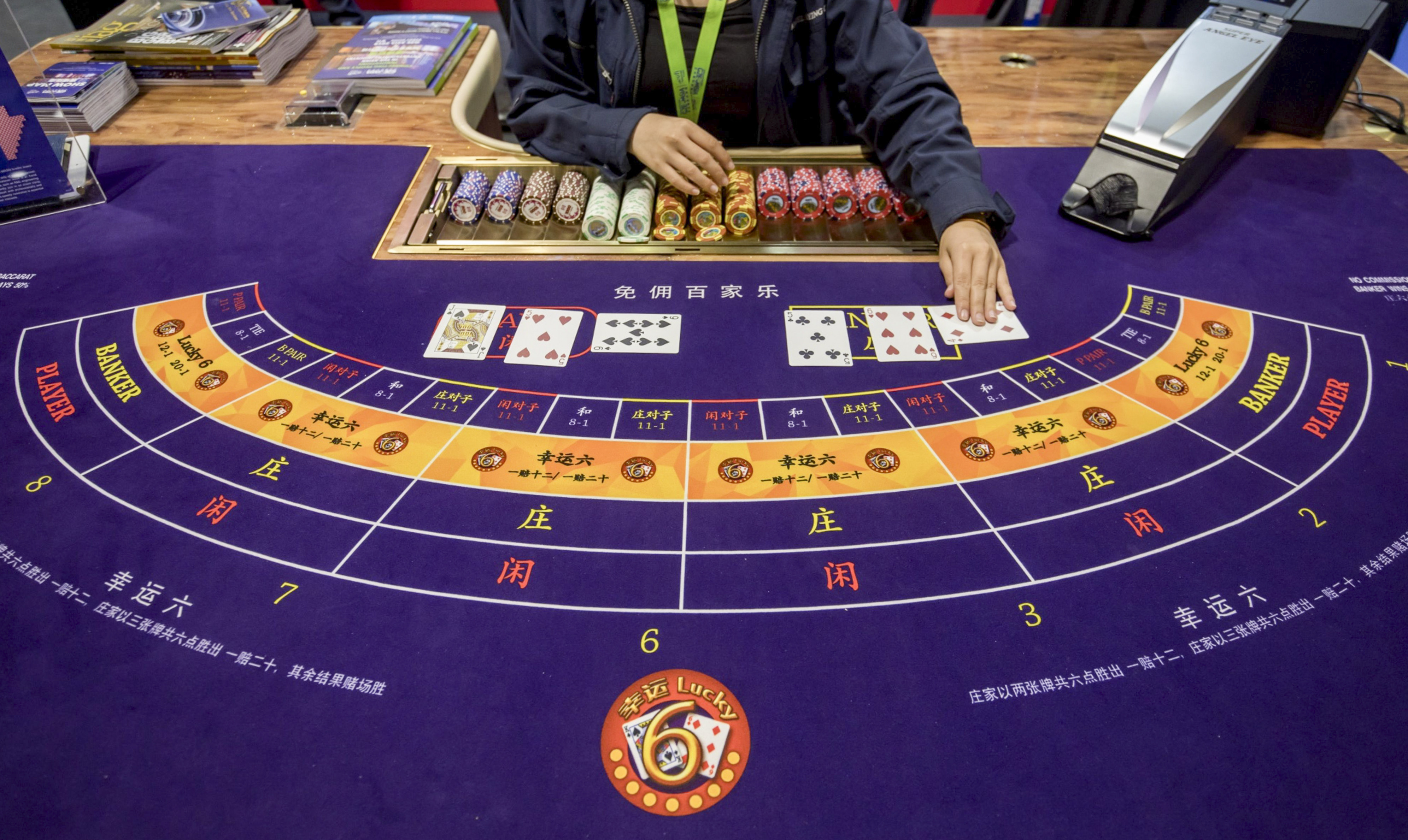 Cards are handled on a baccarat table during the Global Gaming Expo Asia (G2E Asia) in Macau, China, on Tuesday, May 21, 2019. The expo runs through May 23. Photographer: Paul Yeung/Bloomberg