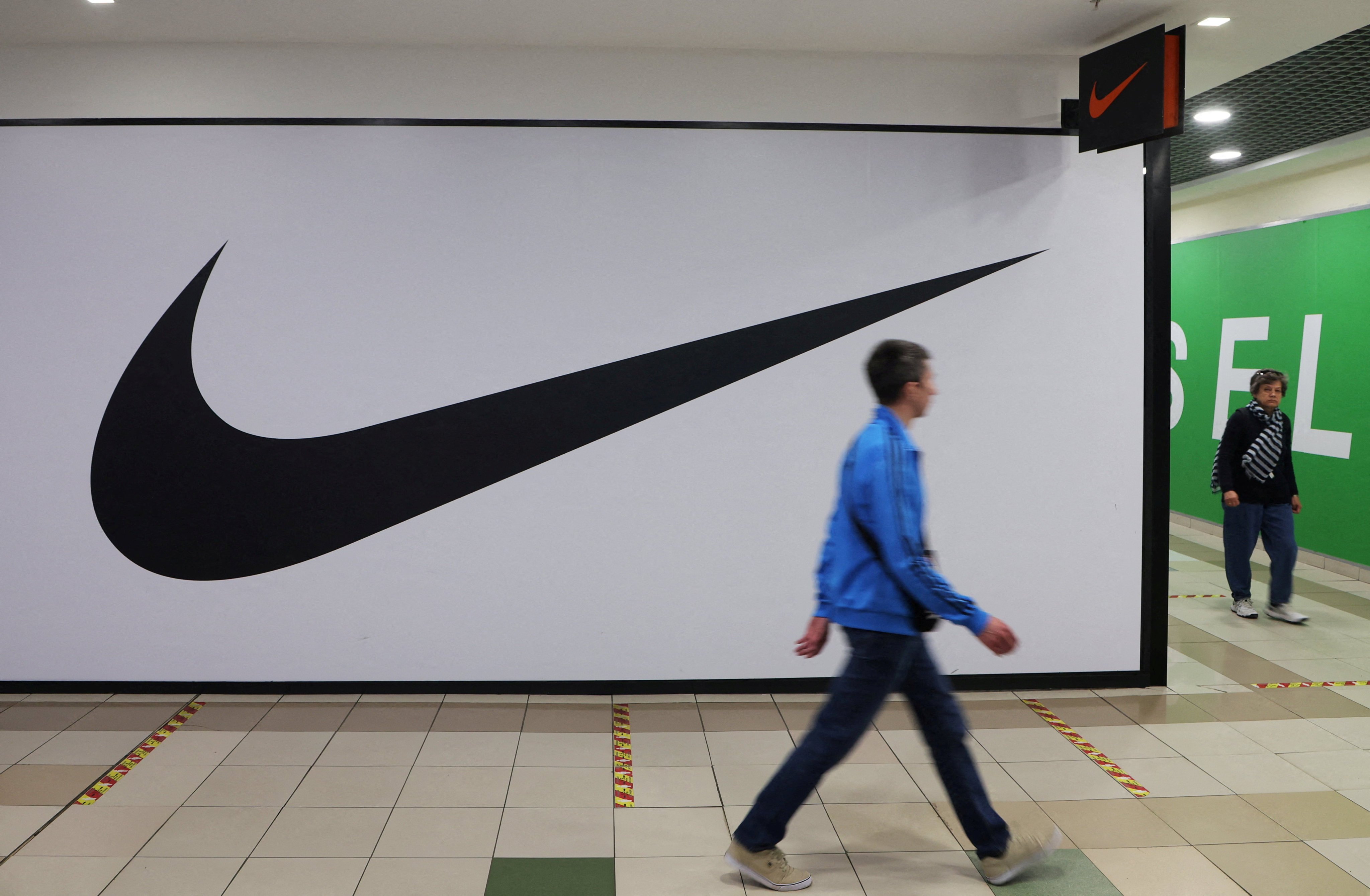 A man walks past a closed Nike shop at a shopping mall in Saint Petersburg, Russia on May 25. Photo: Reuters