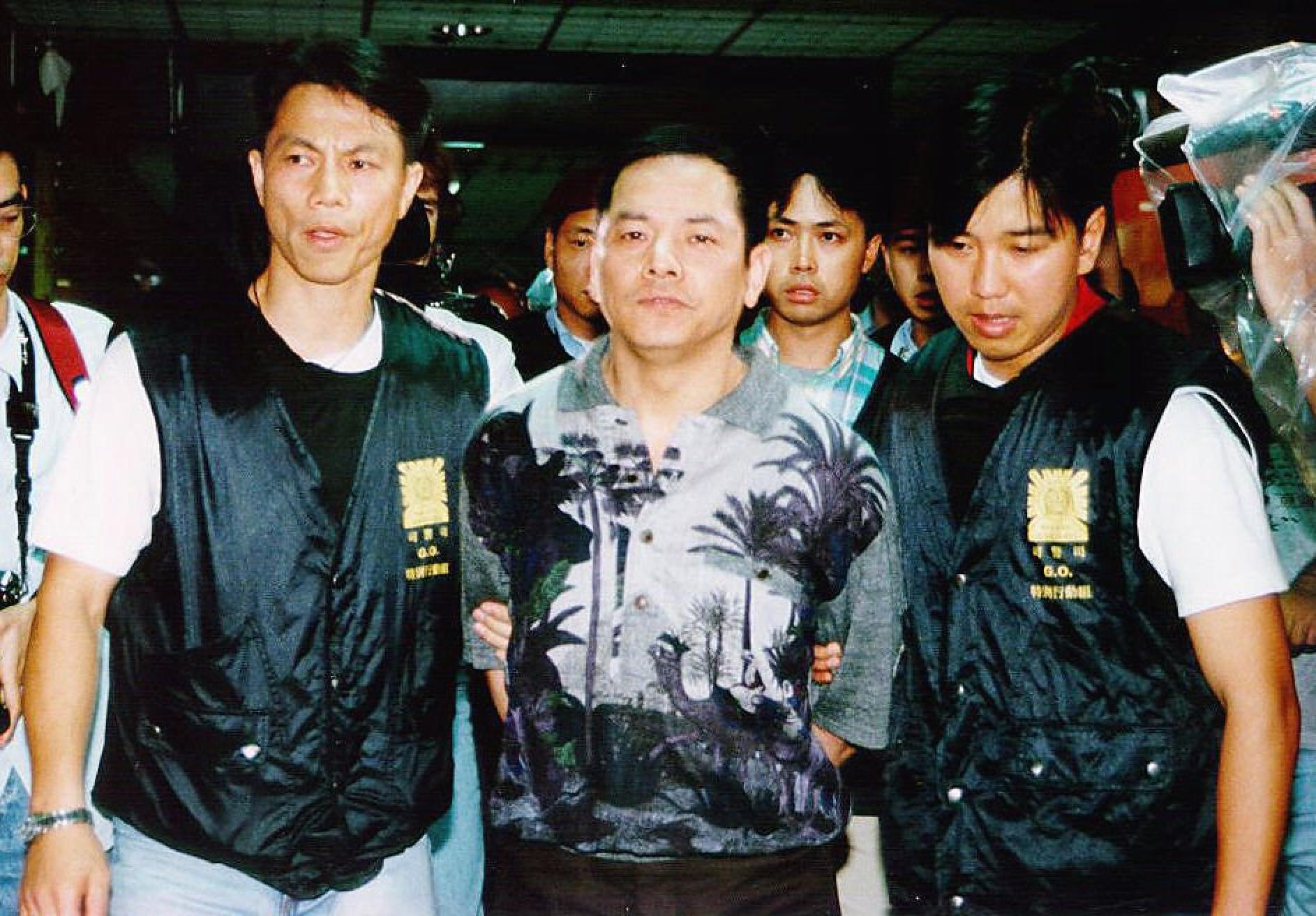 “Broken Tooth” Wan Kuok-koi is escorted by Macau Police to court in May 1998. Photo: SCMP