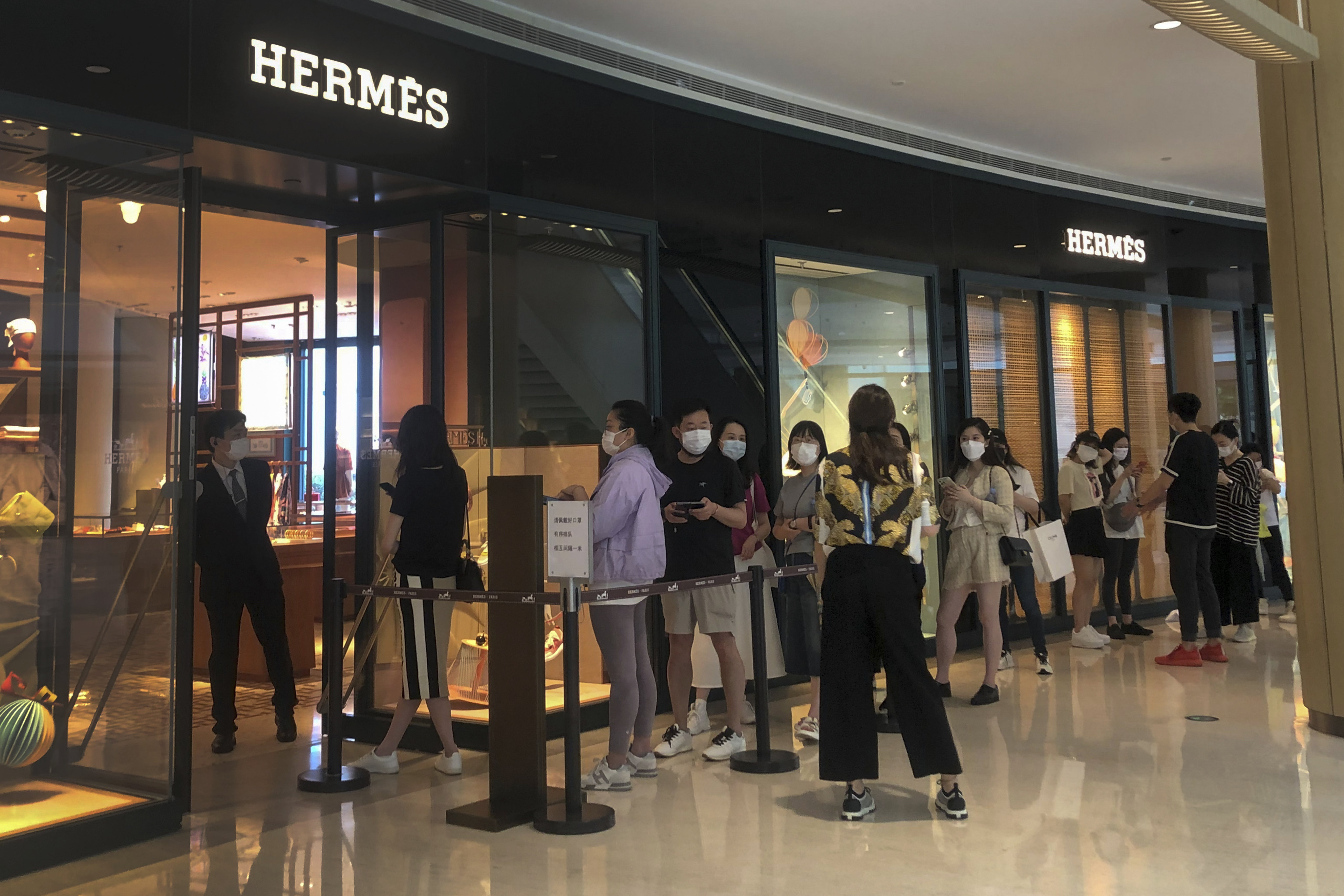 People queue outside a store in a shopping centre that reopened after months of Covid-19 restrictions in Shanghai on May 29. China’s services sector is expected to rebound. Photo: AP