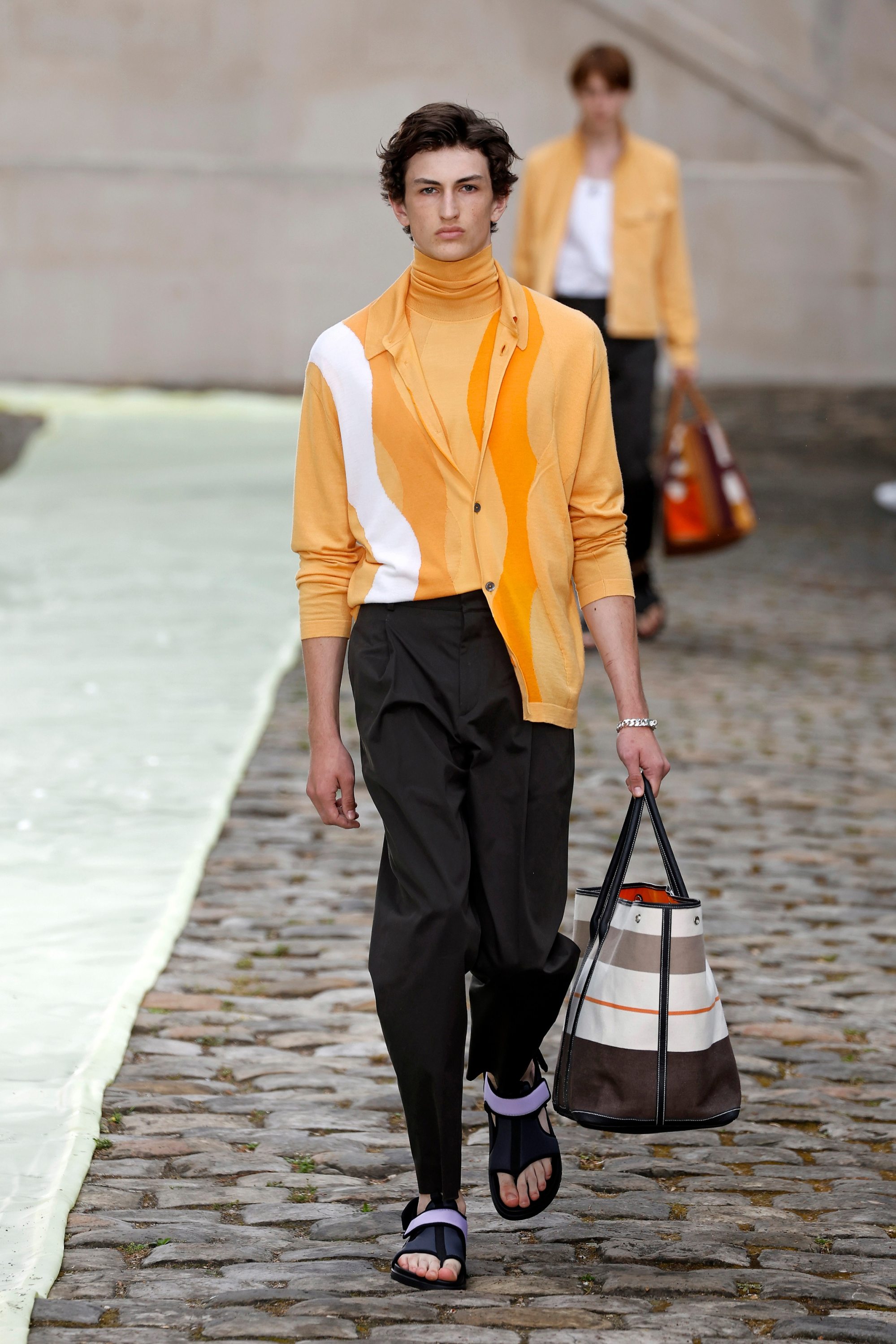 Hermès brought summer holiday vibes to Paris Fashion Week with pastel  colours and a contemporary take on Birkin's ancestor – the Haut à courroies  travel bag – for its menswear spring/summer 2023