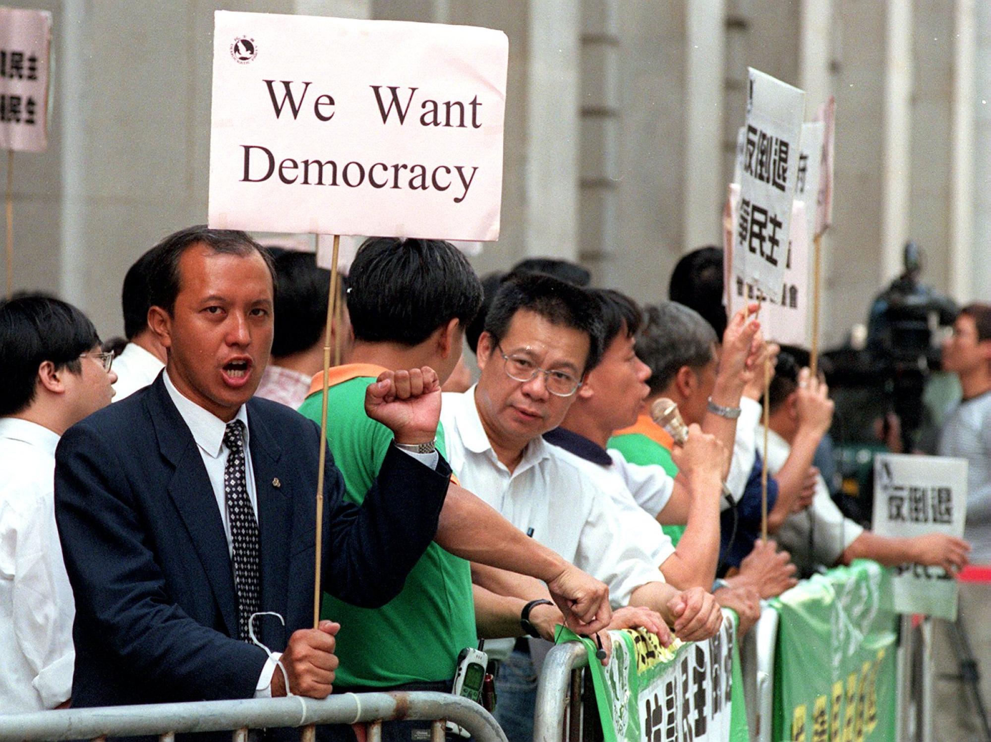Democratic Party members protest outside the Legislative Council on October 13, 1999. Photo: Antony Dickson