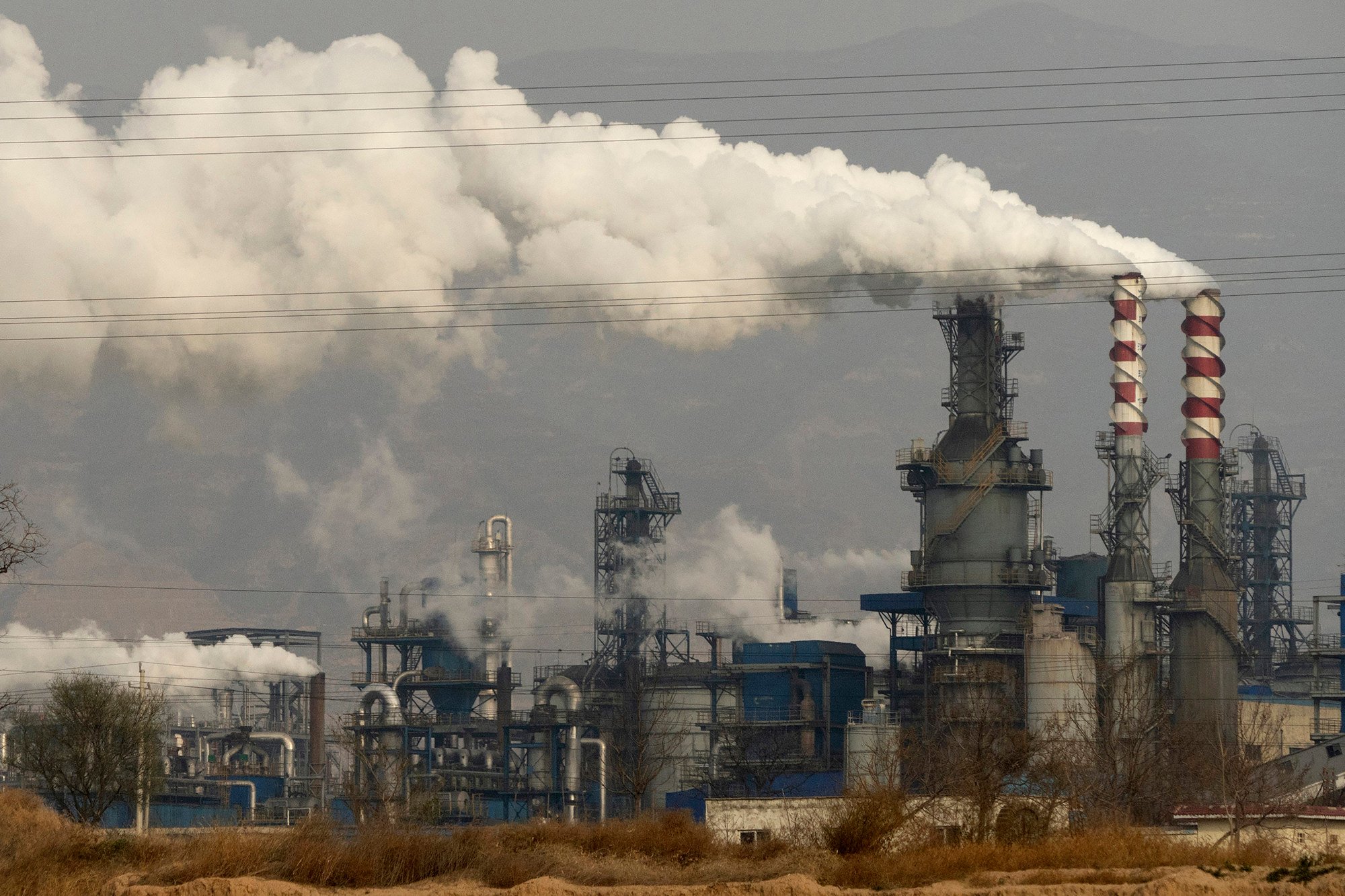 Smoke and steam rise from a coal-processing plant in Hejin in central China’s Shanxi Province in November 2019. MSCI’s new report names 10 large listed companies that have not reported on their greenhouse-gas emissions, including seven Chinese firms. Photo: AP