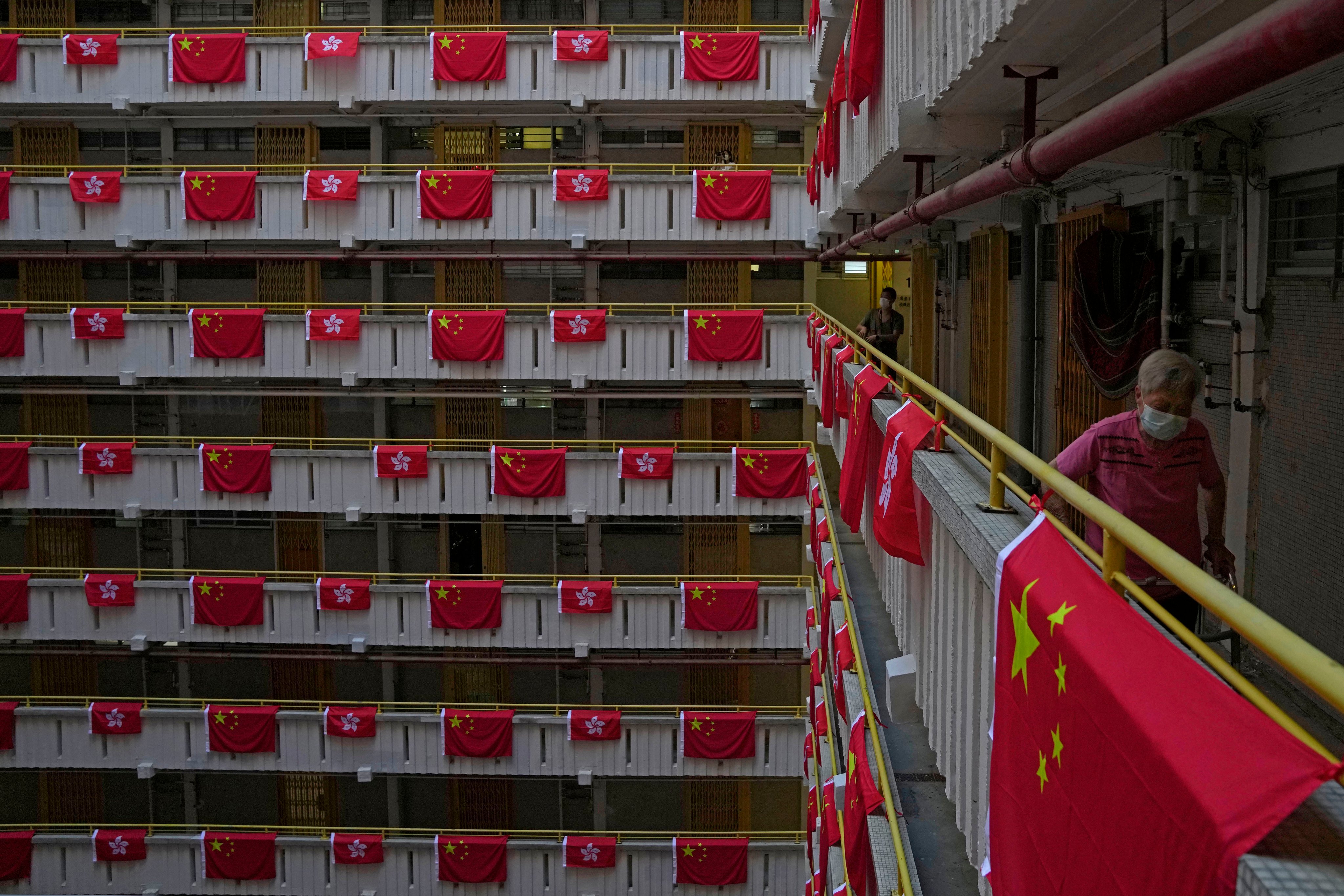 Chinese and Hong Kong flags hang over the walkways at a public housing estate in the city on June 25. Photo: AP
