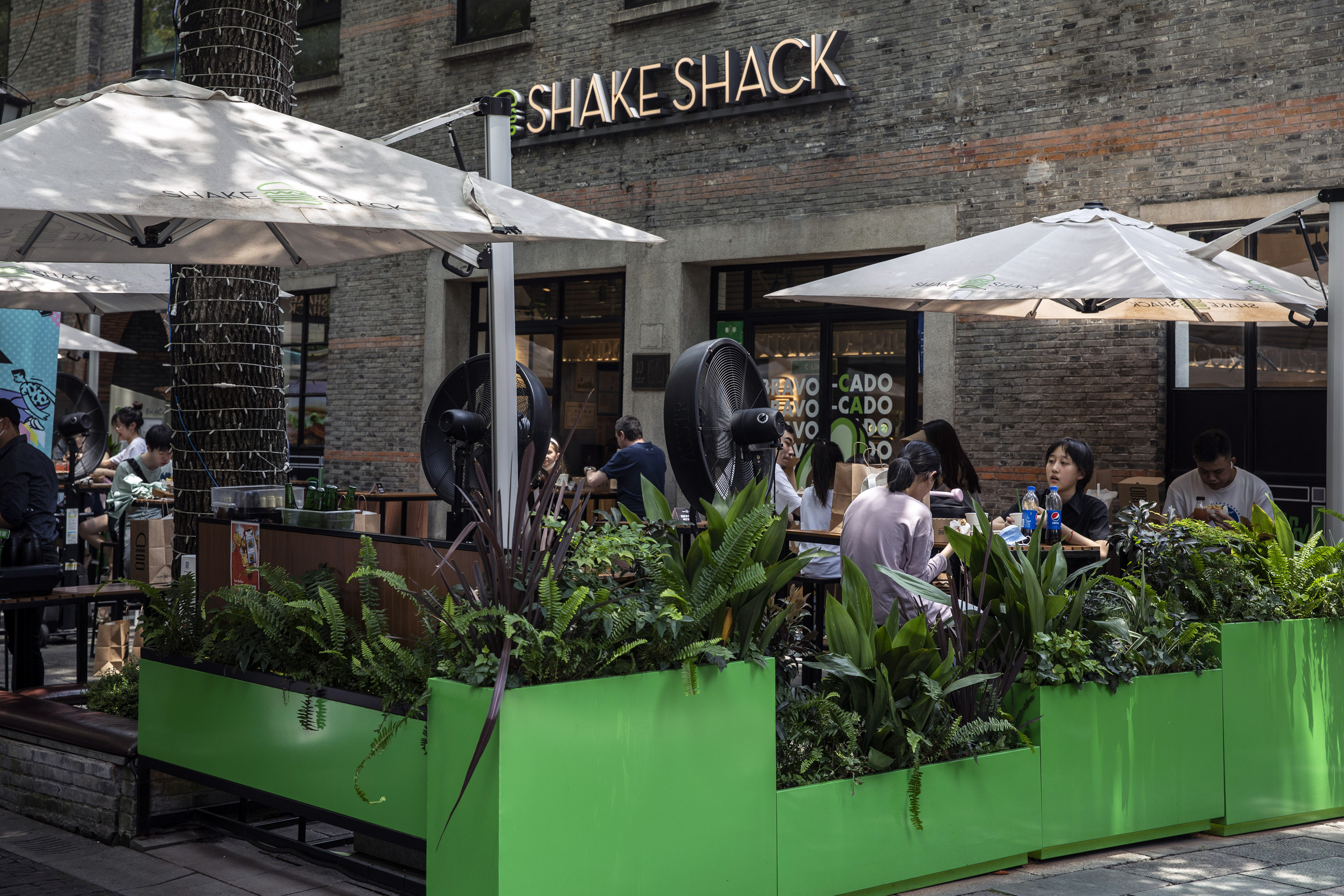 Customers at a Shake Shack restaurant in Shanghai on June 29. Lingering Covid-19 restrictions are making recovery more challenging for the service sector. Photo: Bloomberg