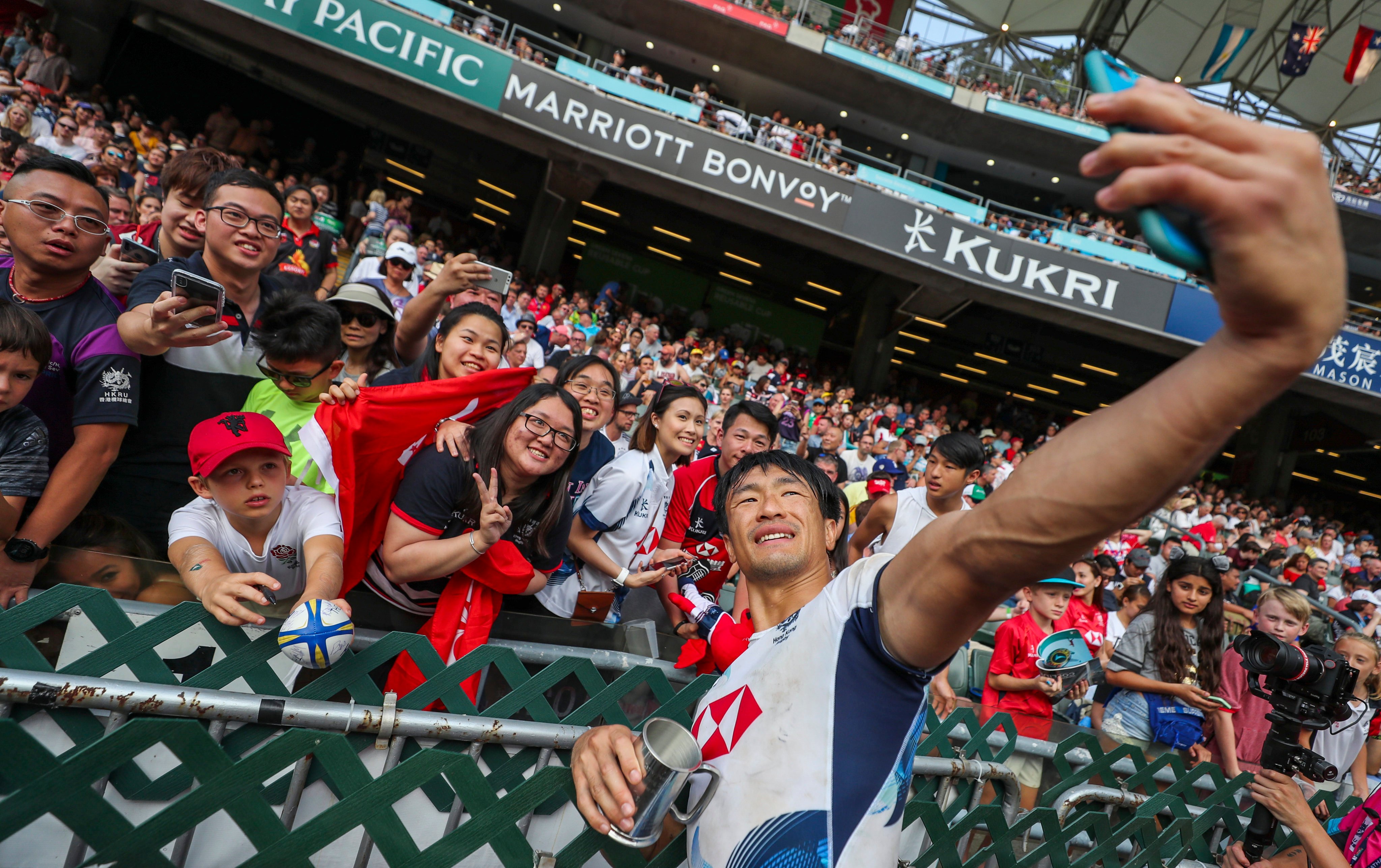 Salom Yiu Kam-shing of Hong Kong takes a selfie with fans after the men’s qualifier final against Ireland on the last day of the Hong Kong Sevens at Hong Kong Stadium on April 7, 2019. The event has been suspended for two years because of the pandemic. Photo: Sam Tsang