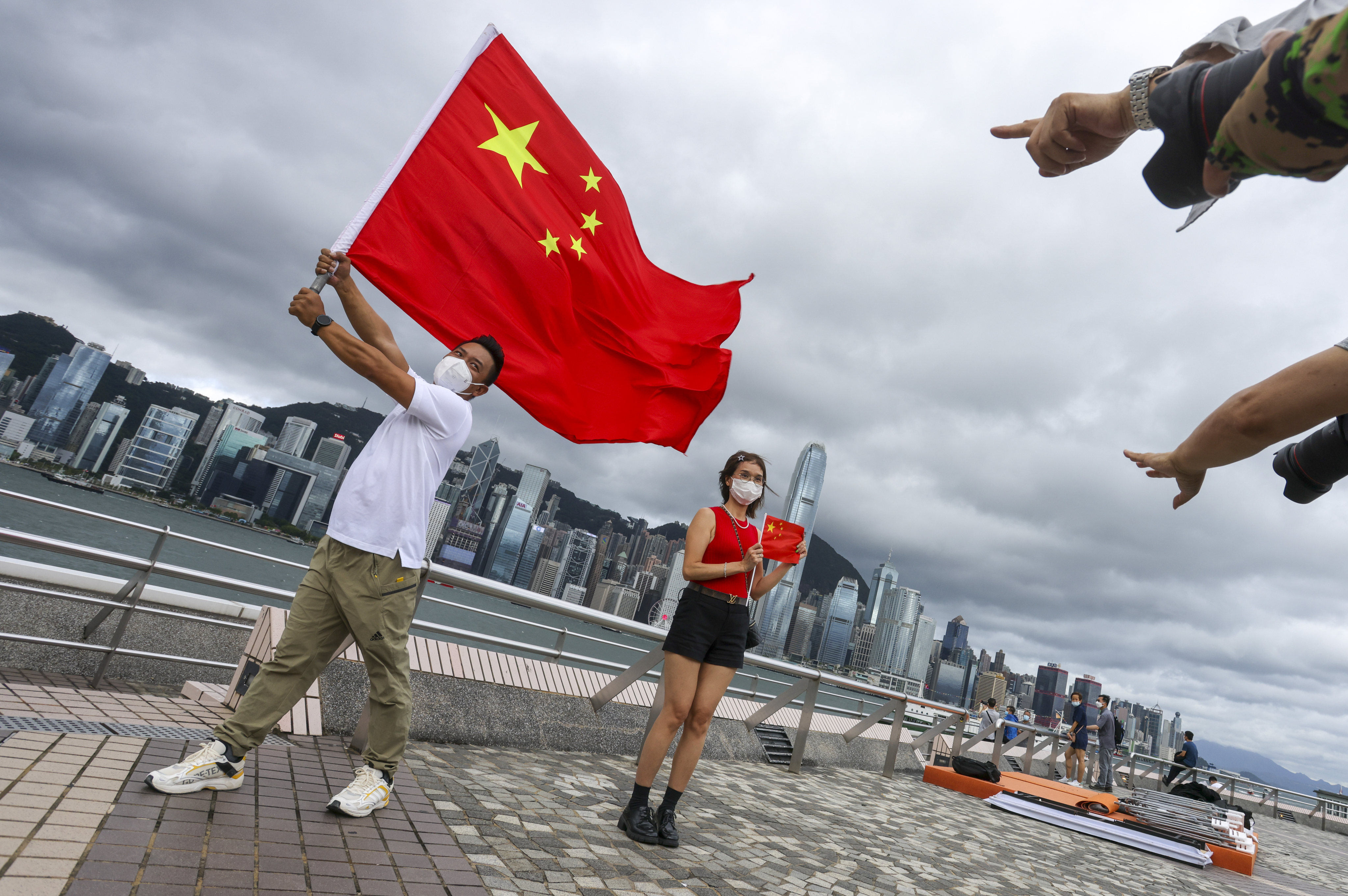 Residents celebrate the 25th anniversary of the city’s handover on the Tsim Sha Tsui promenade on Friday. Photo: Nora Tam