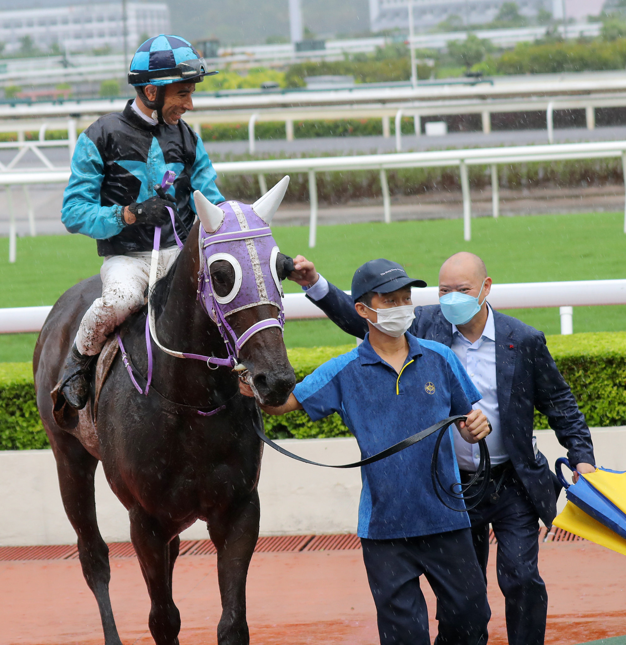 Trainer Chris So and jockey Joao Moreira celebrate.