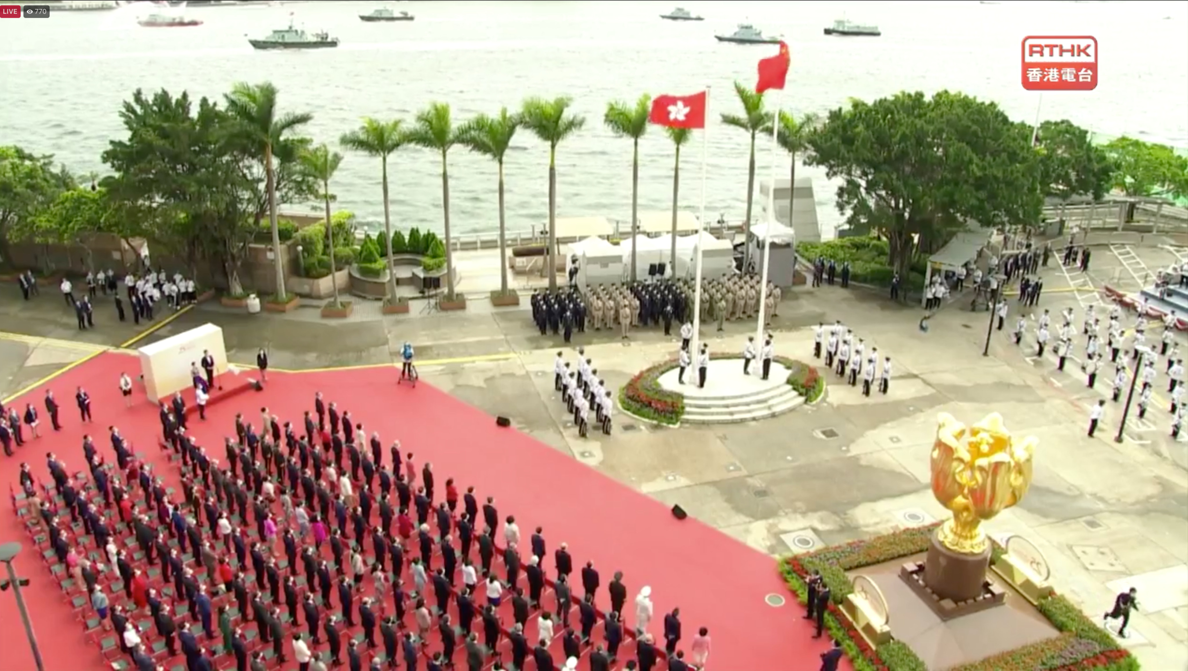 Hong Kong officials in Wan Chai attend a flag-raising ceremony under inclement weather. Photo: RTHK