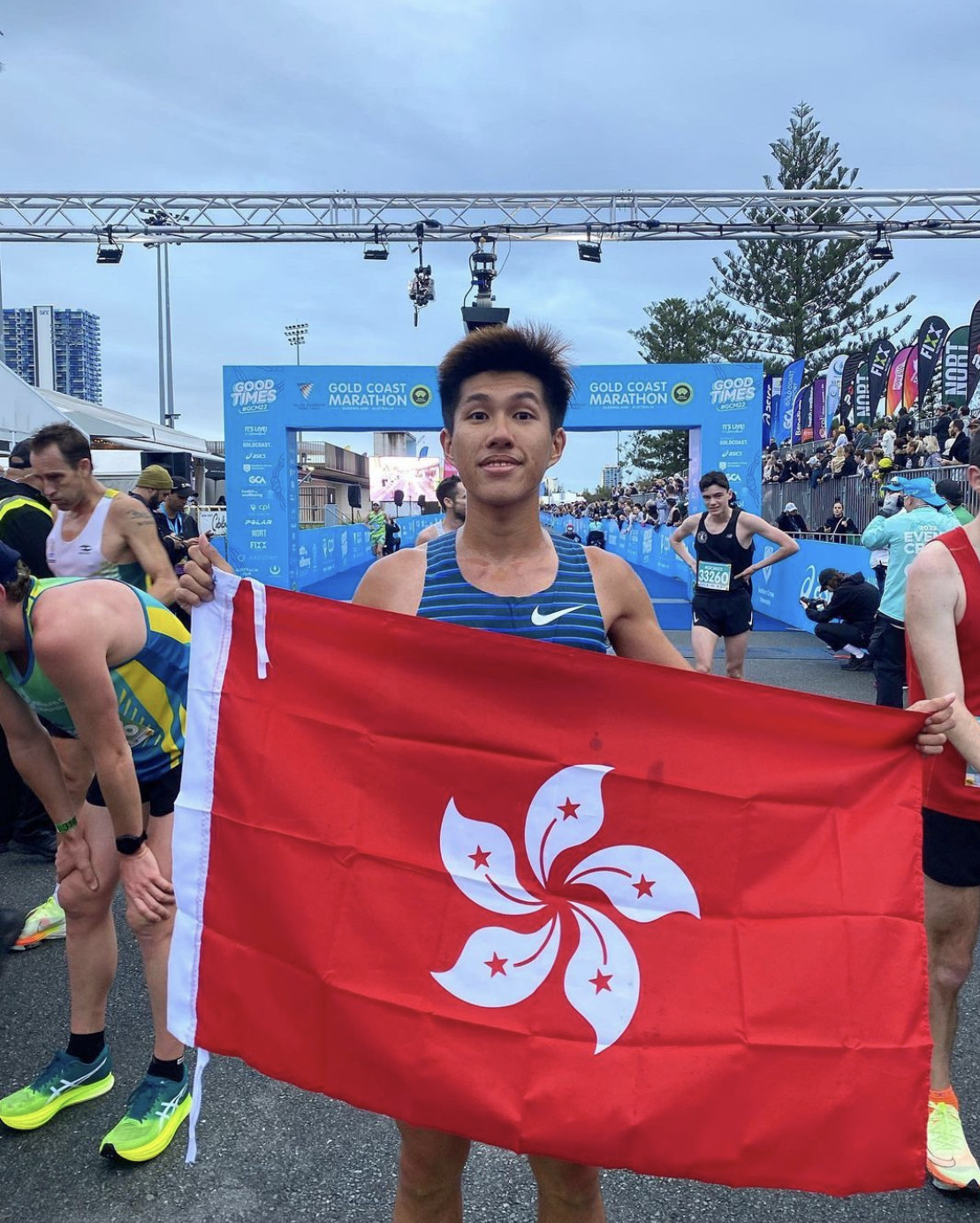 Wong Wan-chun grabs a Hong Kong flag after crossing the finish line in Australia. Photo: Instagram