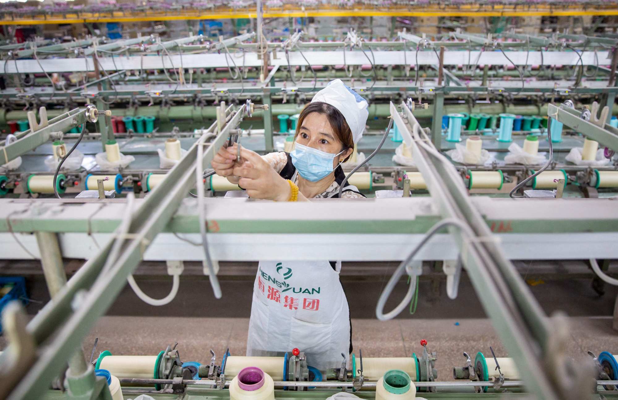 A worker produces silk products for export at a textile factory in Nantong, in China’s eastern Jiangsu province, on June 15. Photo: AFP