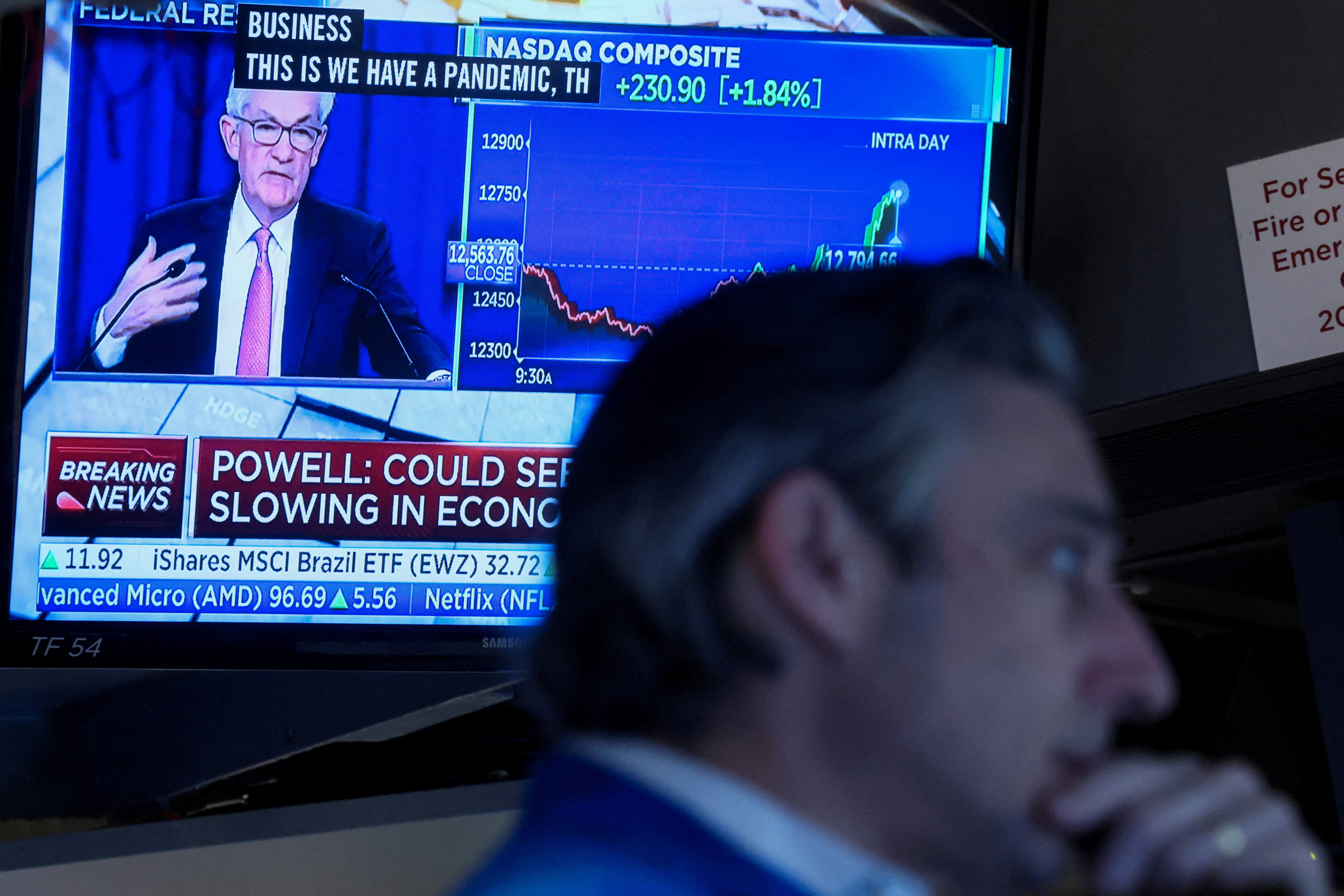 A trader works on the floor of the New York Stock Exchange on May 4 as US Federal Reserve chairman Jerome Powell delivers remarks on a screen. Photo: Reuters