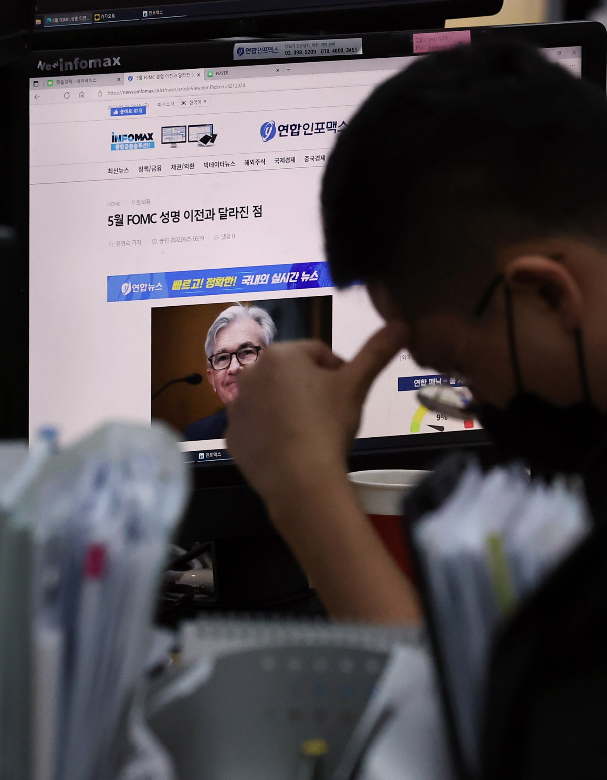 A currency trader ponders a news report on the US Federal Reserve’s decision to raise key interest rates by half a percentage point, in the dealing room of Hana Bank in Seoul on May 6. Photo: EPA-EFE