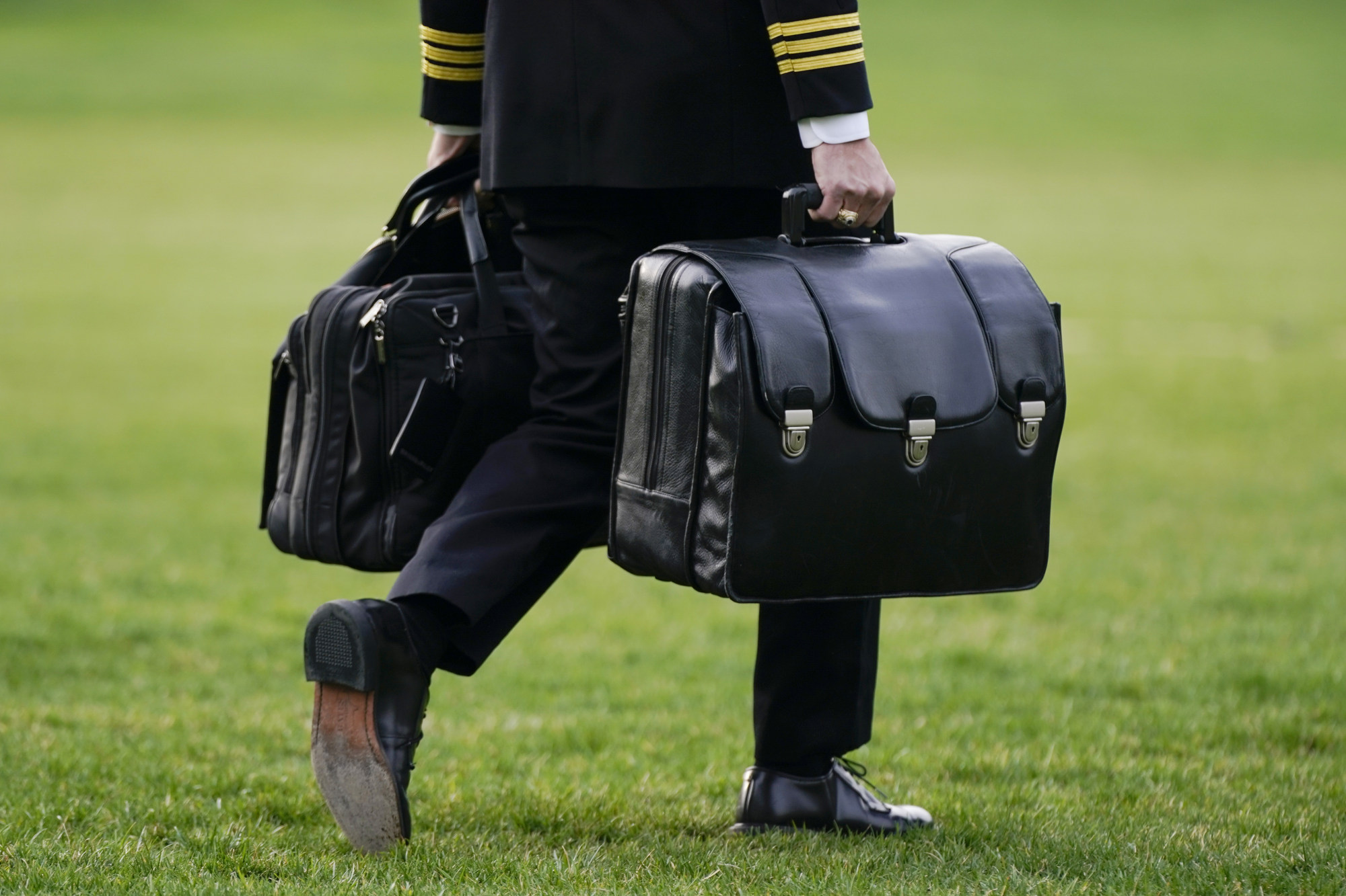A military aide carries the “president’s emergency satchel”, also known as “the football” which contains nuclear launch codes, before boarding Marine One behind US President Joe Biden on the South Lawn of the White House on March 23 in Washington. Photo: AP