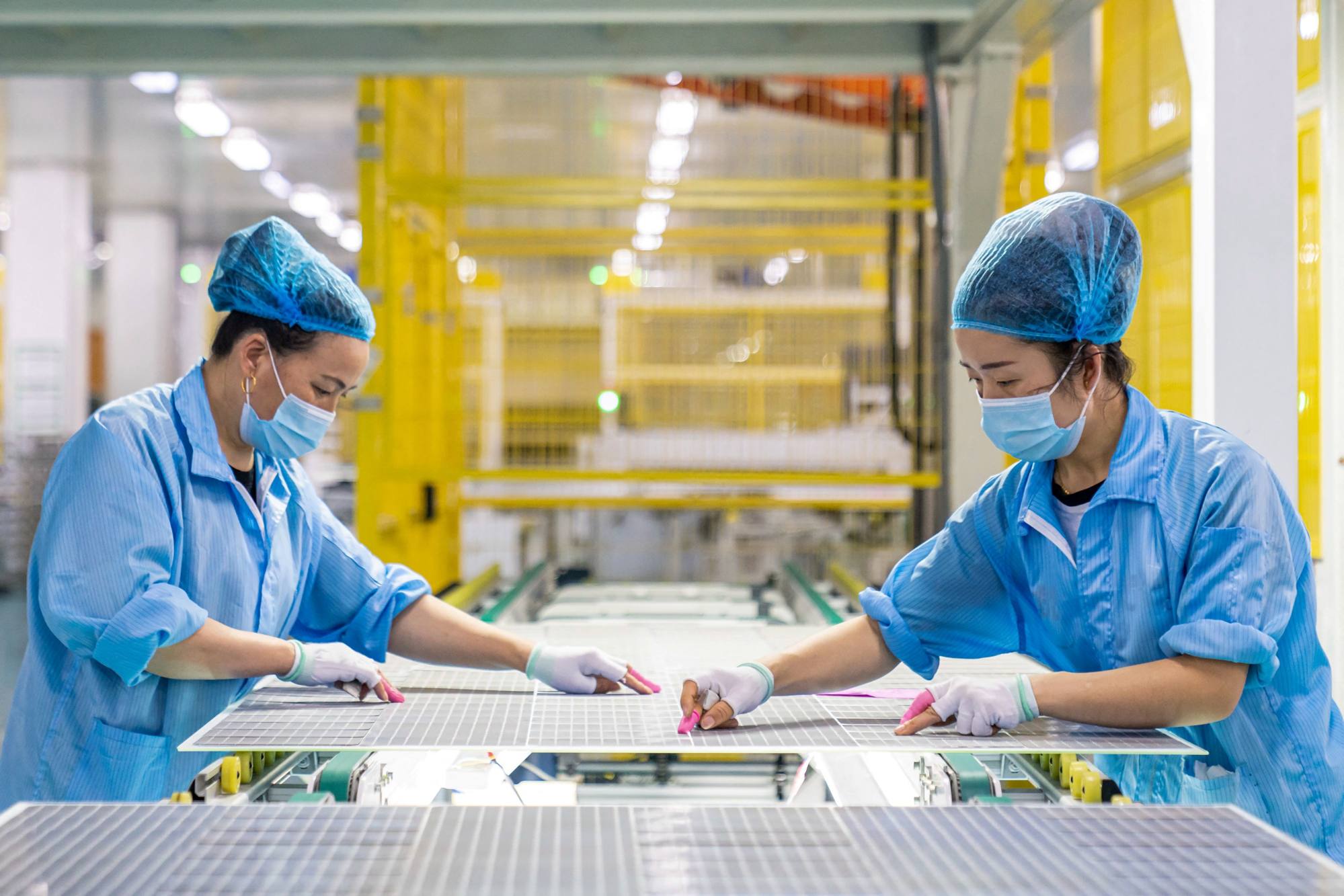 Workers assembling solar photovoltaic modules used for small solar panels at a factory in Haian in eastern China’s Jiangsu province on January 7, 2022. Photo: Agence France-Presse