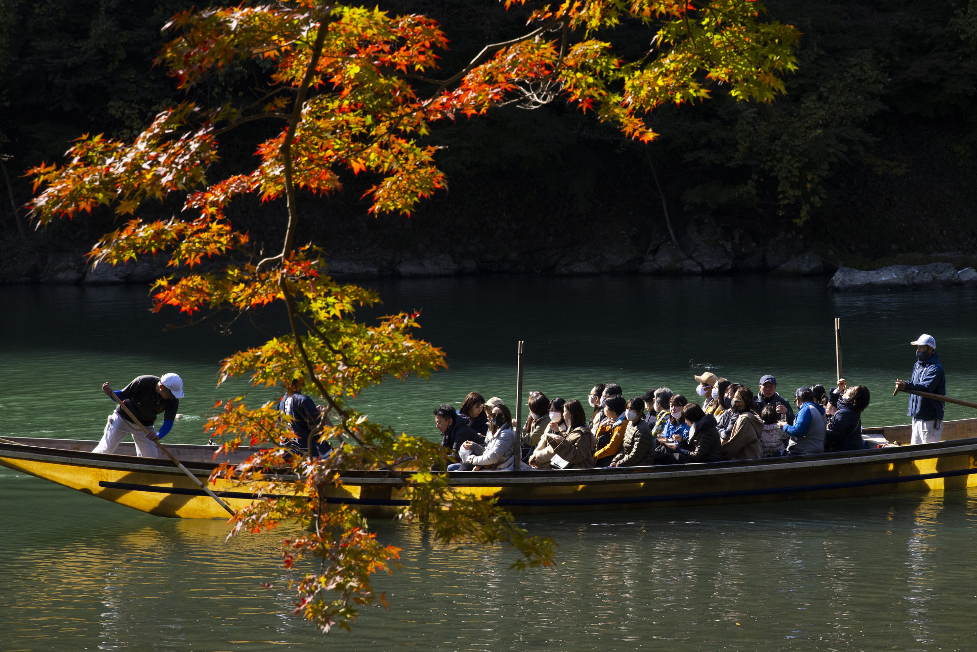 A sightseeing boat takes tourists along the Oi River at Arashiyama, one of Kyoto’s most popular tourist destinations. Photo: Getty Images