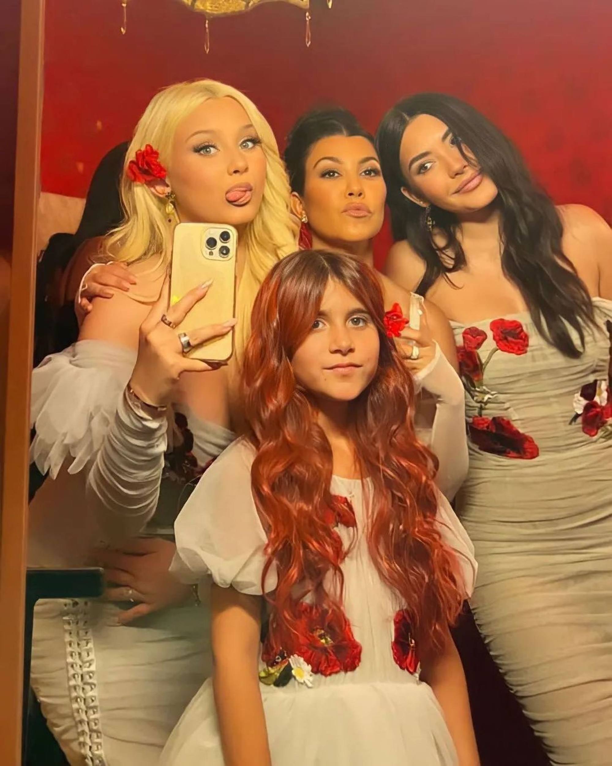 Kourtney Kardashian (centre) with Travis Barker’s children Alabama and Atiana, and Penelope Disick sporting her long red locks. Photo: @kardashian.jenner.andco/Instagram