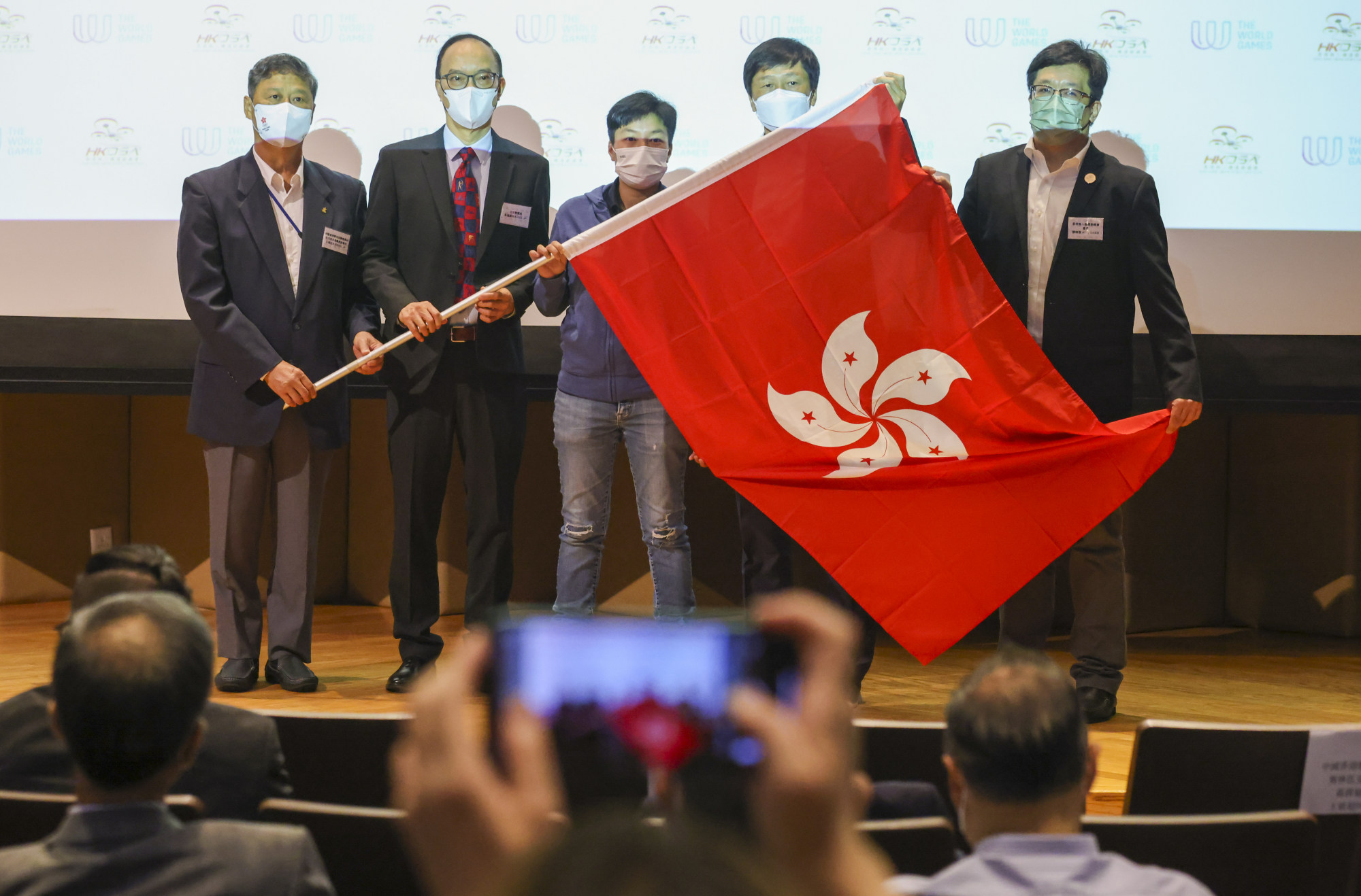 Hong Kong drone racing delegate Kenix Lai Ka-ki (centre) at a flag presentation ceremony ahead of her trip to the 2022 World Games in Birmingham, Alabama, at Olympic House in So Kon Po. Photo: Nora Tam