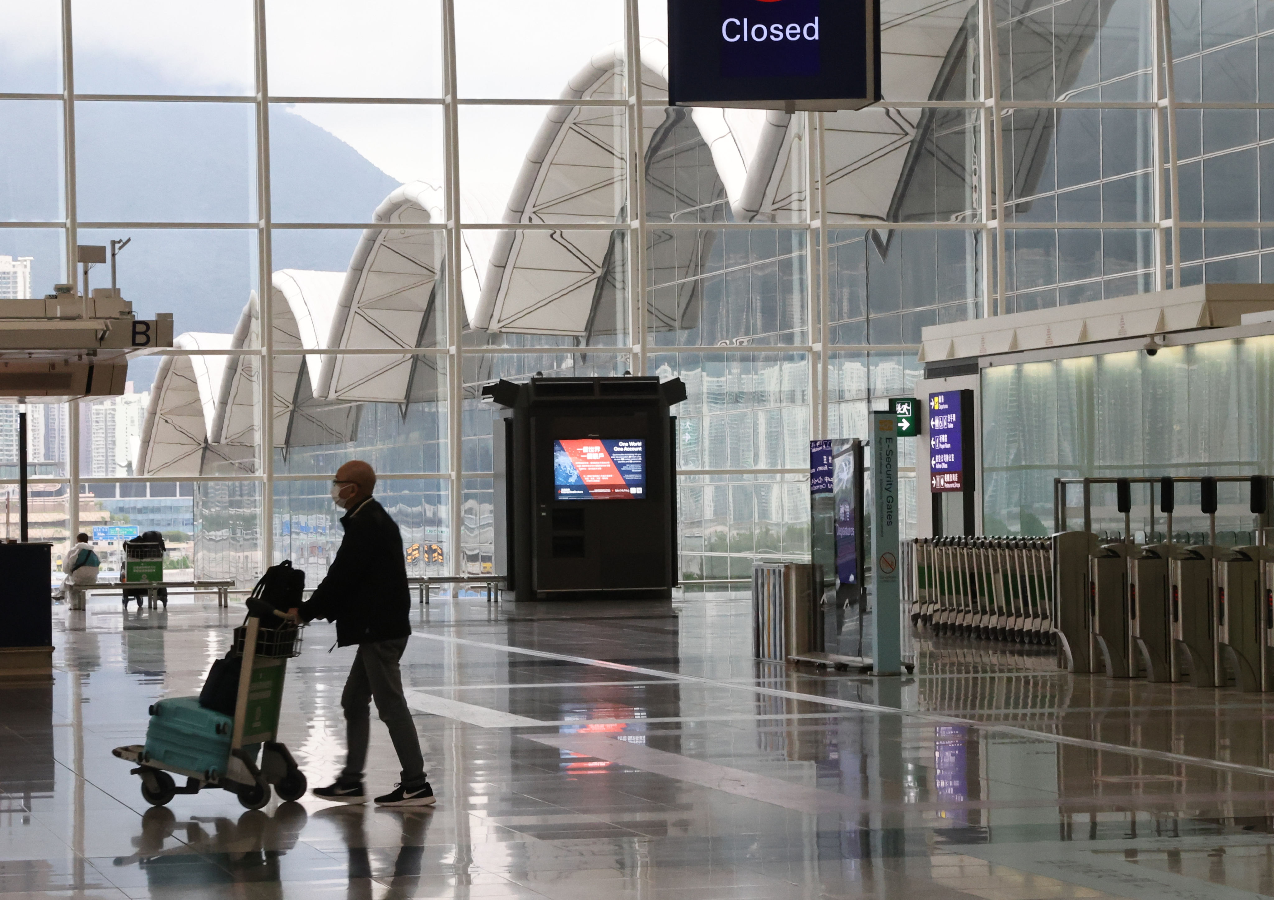 A man enters the departure terminal at Hong Kong International Airport on March 29, 2022. Photo: SCMP / K. Y. Cheng