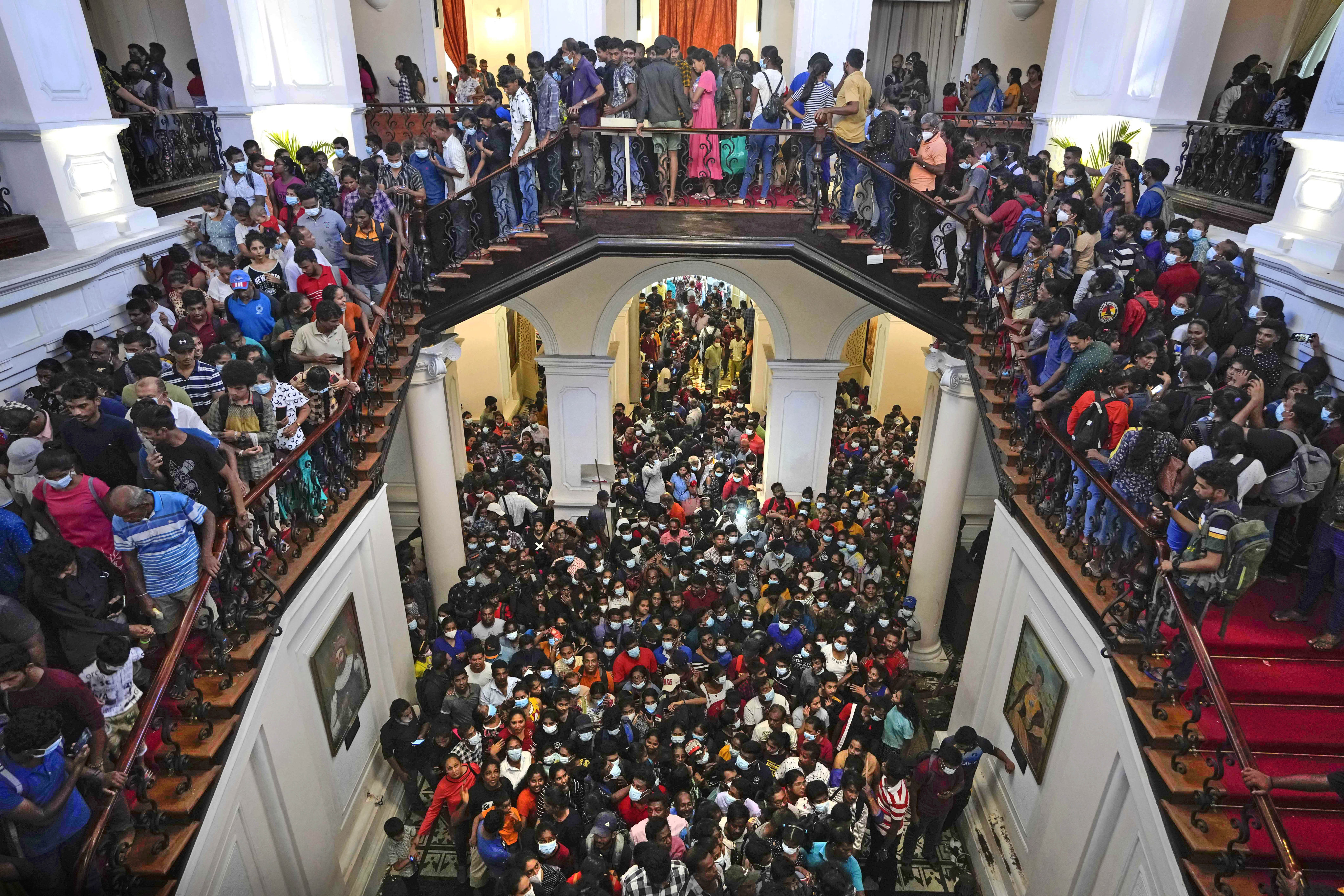 Sri Lankans gather inside President Gotabaya Rajapaksa’s official residence in Colombo. Photo: AP