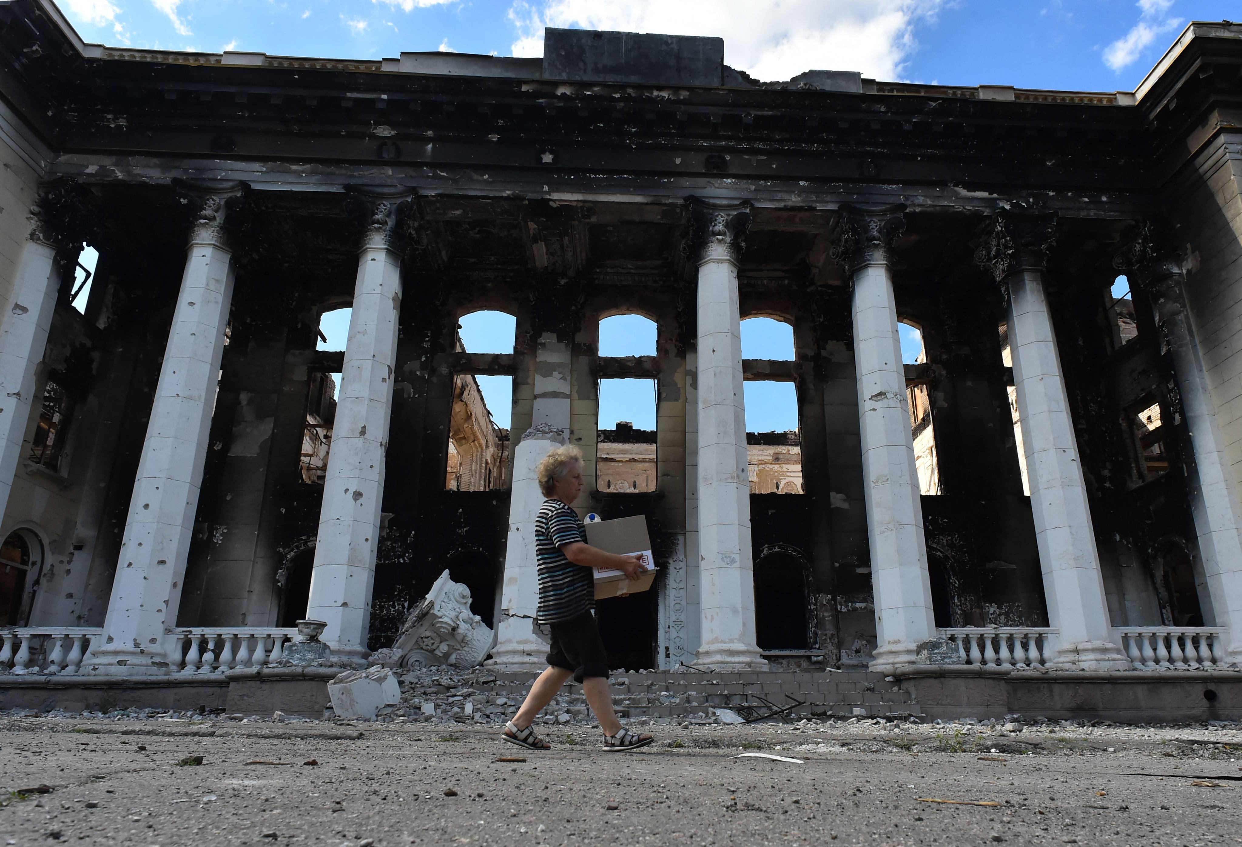 A resident walks past destroyed buildings in the city of Lysychansk, Ukraine, on July 12. Photo: AFP