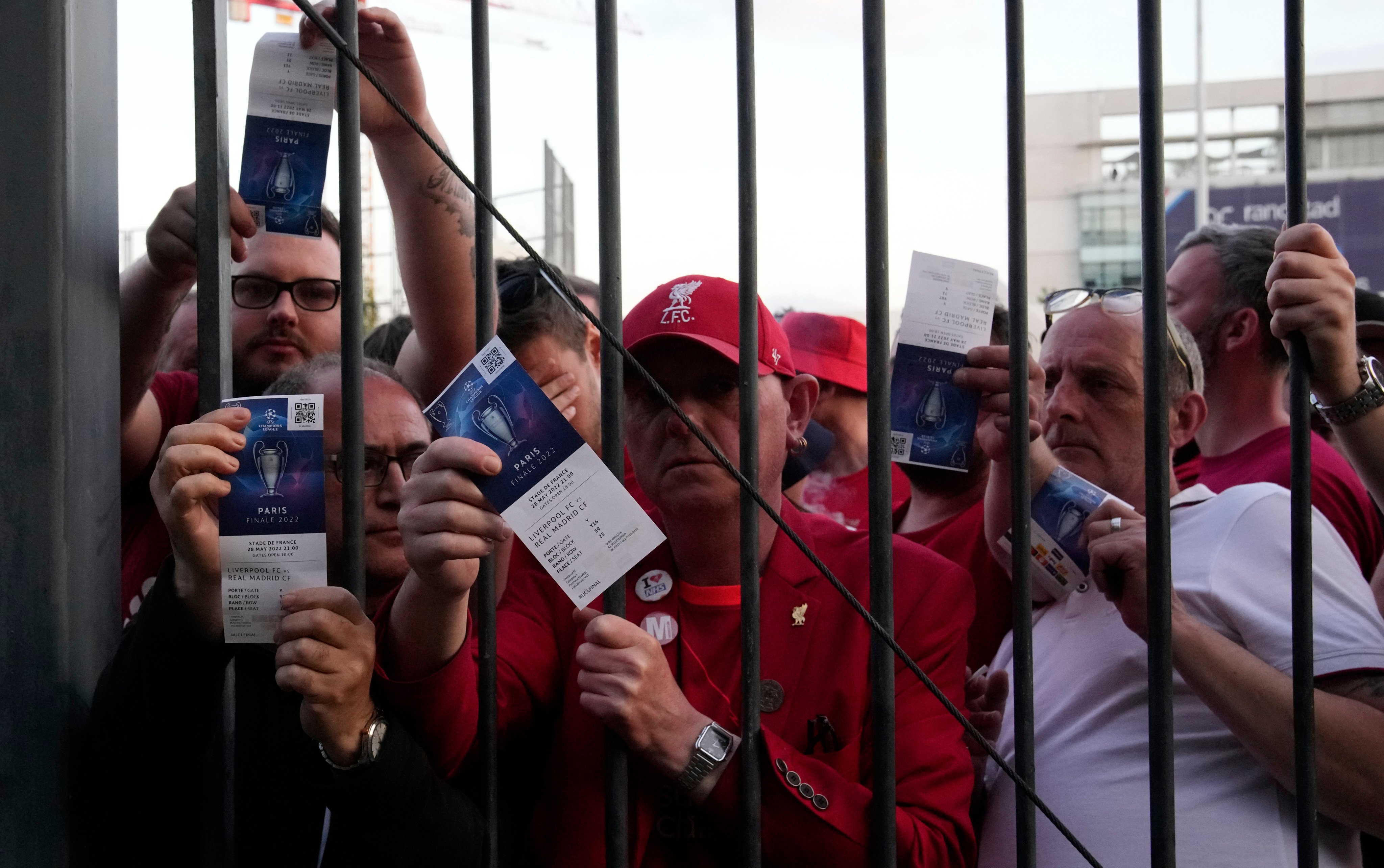 Liverpool fans show tickets and wait in front of the Stade de France before the Champions League final between Liverpool and Real Madrid. Photo: AP