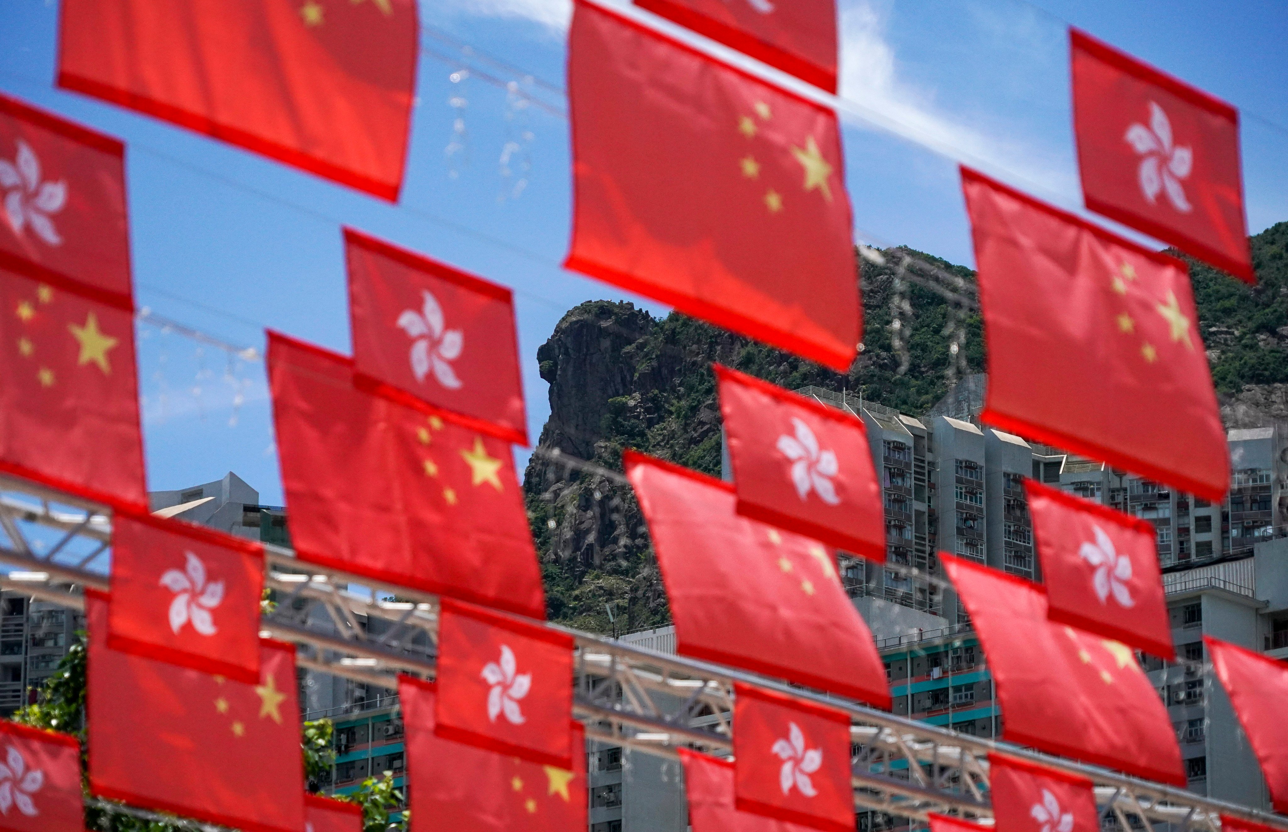 The Lion Rock is seen behind Chinese and Hong Kong flags, put up to mark the 25th anniversary of Hong Kong’s return to Chinese sovereignty, on June 26. Photo: Felix Wong