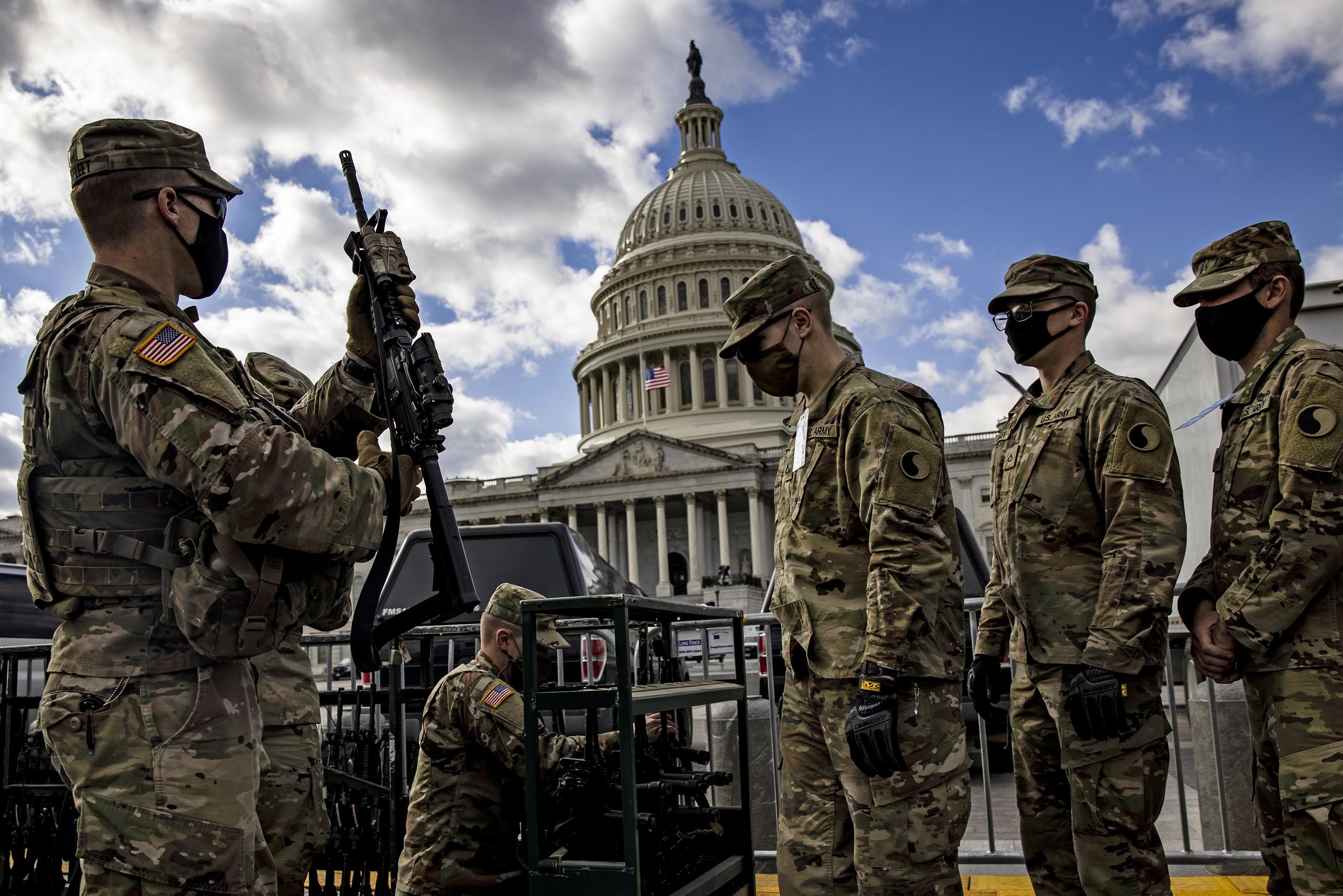 National Guard troops are issued rifles and ammunition outside the US Capitol building in January last year. Photo: Samuel Corum/Getty Images/TNS