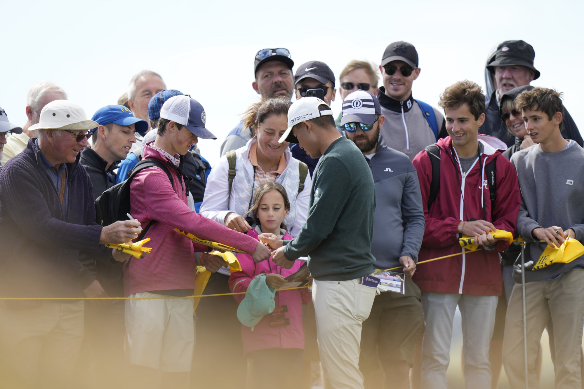 Collin Morikawa signs autographs during a practice round at The Open Championship. Photo: AP