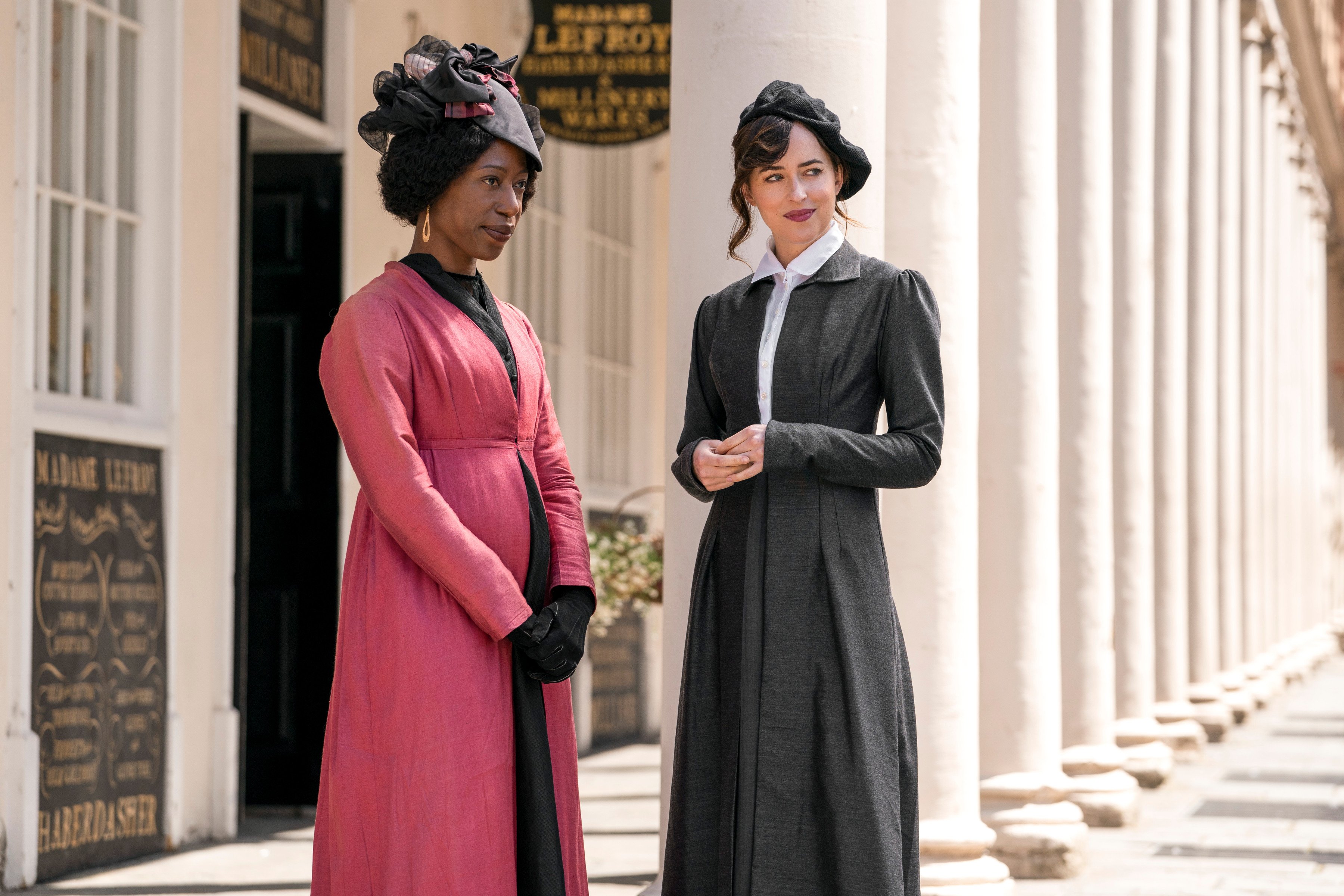Dakota Johnson (right) as Anne Elliott and Nikki Amuka-Bird as Lady Russell in a scene from Persuasion filmed on the colonnaded Bath Street in Bath, southwest England. Photo: Nick Wall / Netflix