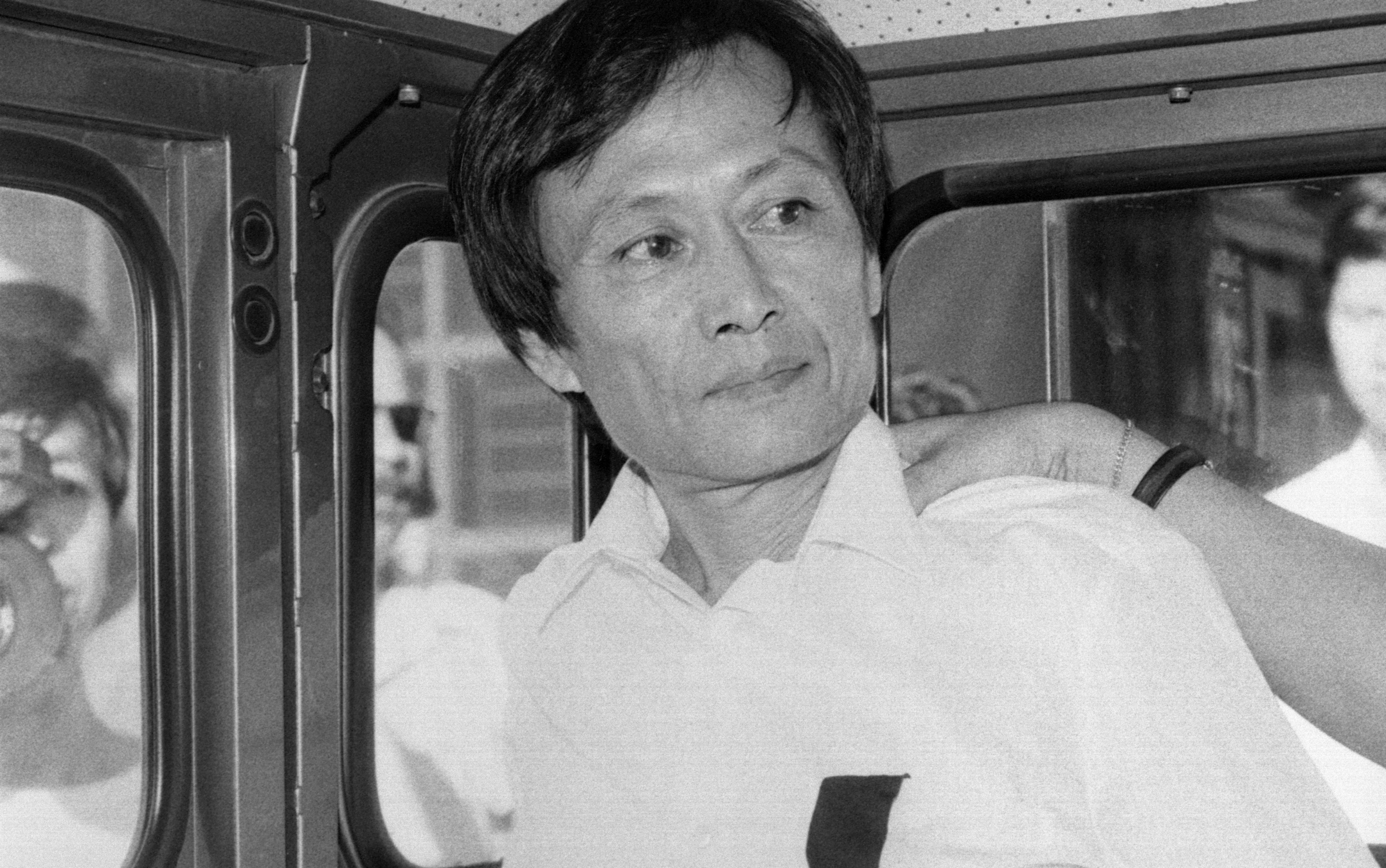 Law Kong (L) on his way back to prison. Law was sent back to the Portuguese enclave from Hong Kong. He would have to serve forty years in jail as he committed crimes, including murder, rape, wounding and robbery, in Macau in 1967. His identity was discovered only when he applied for a Hong Kong identity card.30JUL86 SCMP / Oliver Tsang