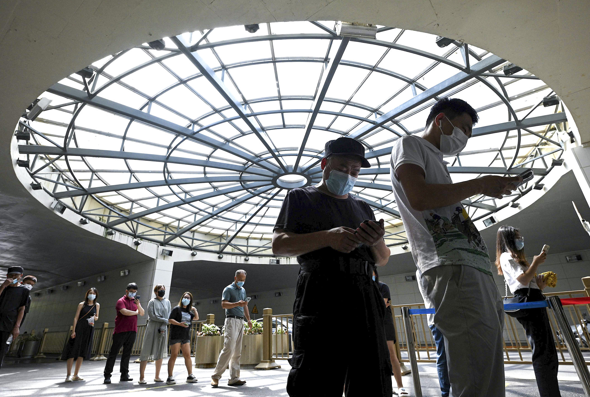 People queue to get tested in Beijing on Wednesday. China is sticking to a strict zero-Covid policy. Photo: AFP