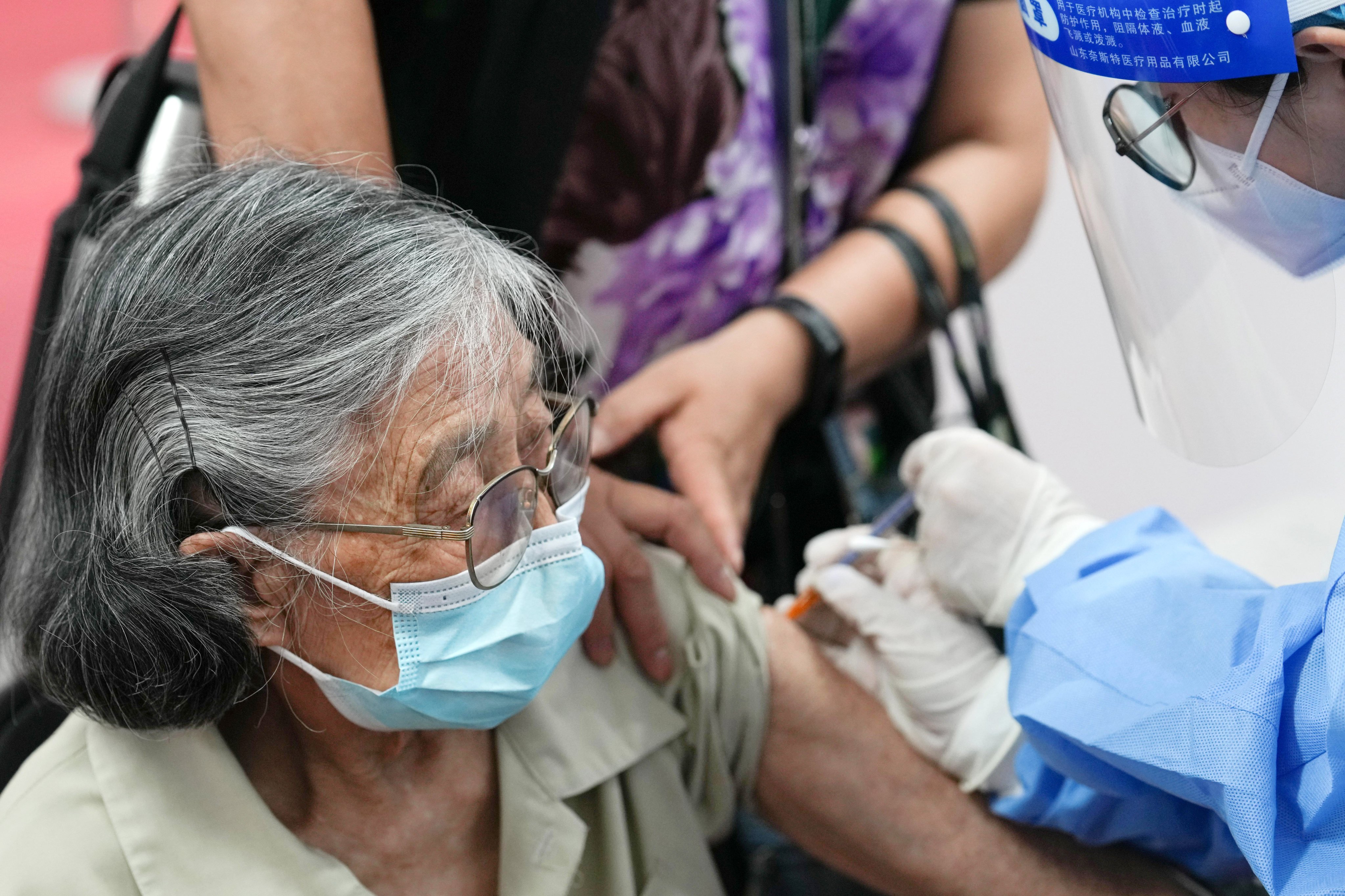 An 89-year-old woman receives a Covid-19 vaccine booster shot at a clinic in Beijing. Photo: Xinhua