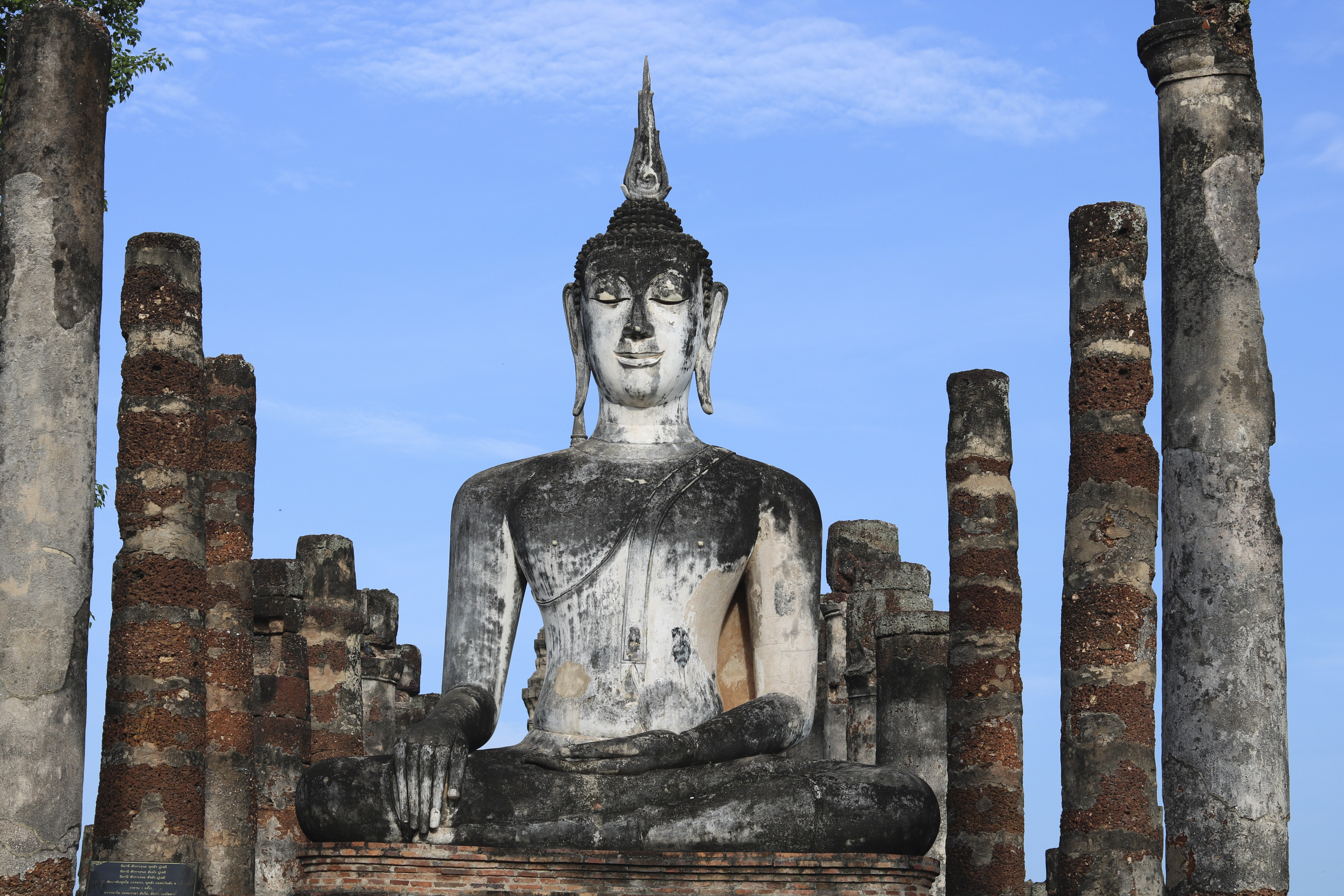 A statue of the Buddha in earth-touching pose in Wat Mahathat, Sukhothai, Thailand. Photo: Thomas Bird
