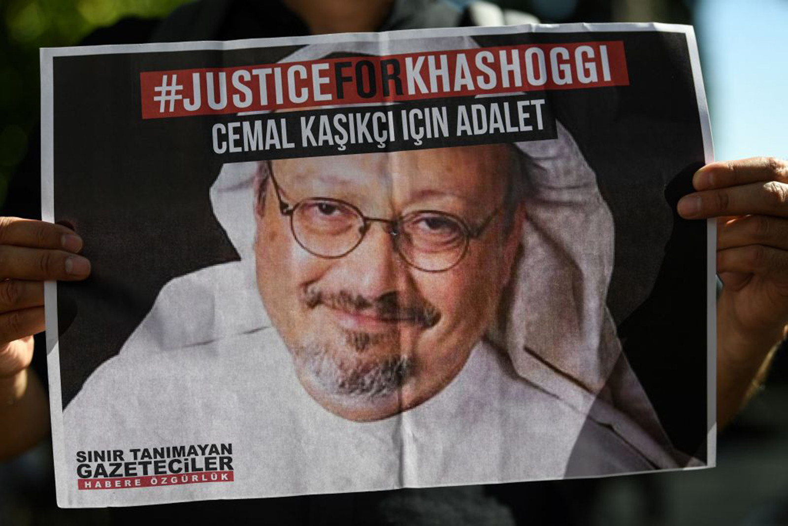 Friends of murdered Saudi journalist Jamal Khashoggi hold posters bearing his picture as they attend an event marking the anniversary of his assassination. Photo: AFP 