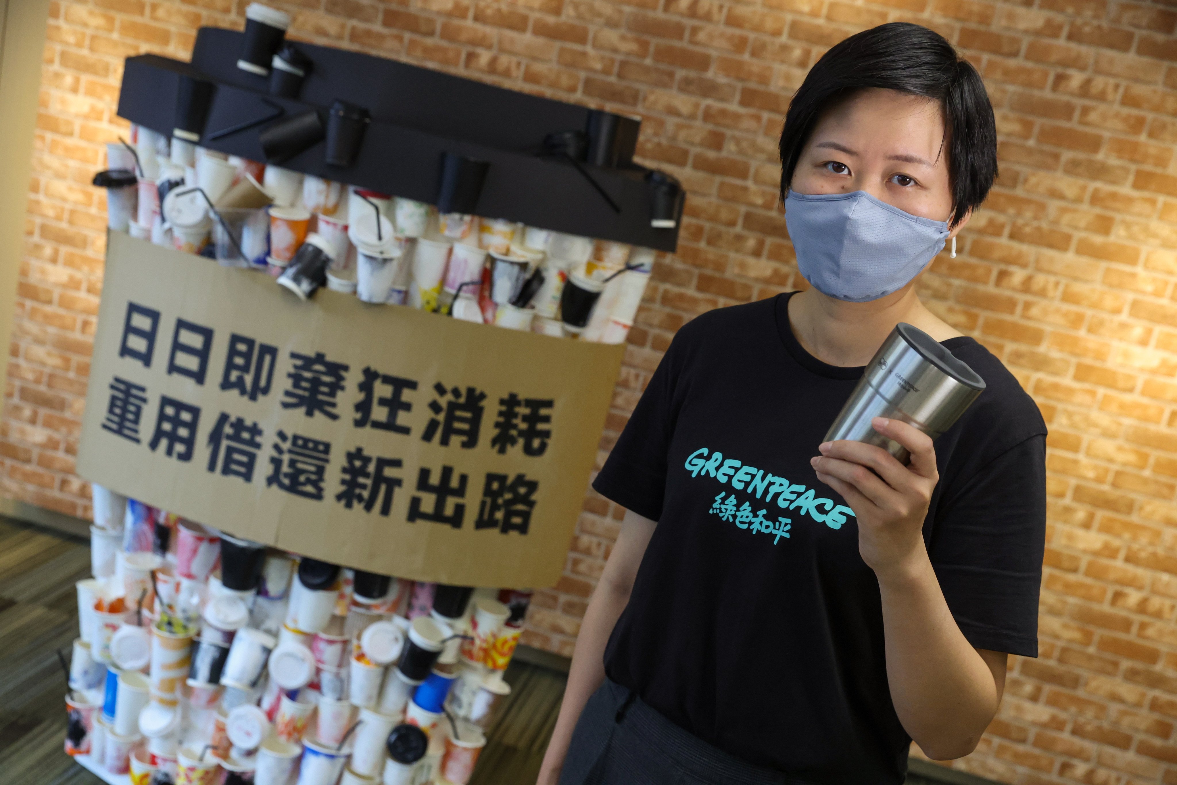 Greenpeace campaigner Leanne Tam said the group is launching its own cup borrowing programme with six coffee shops in Sheung Wan as part of efforts to encourage reusing of utensils. Photo: Edmond So