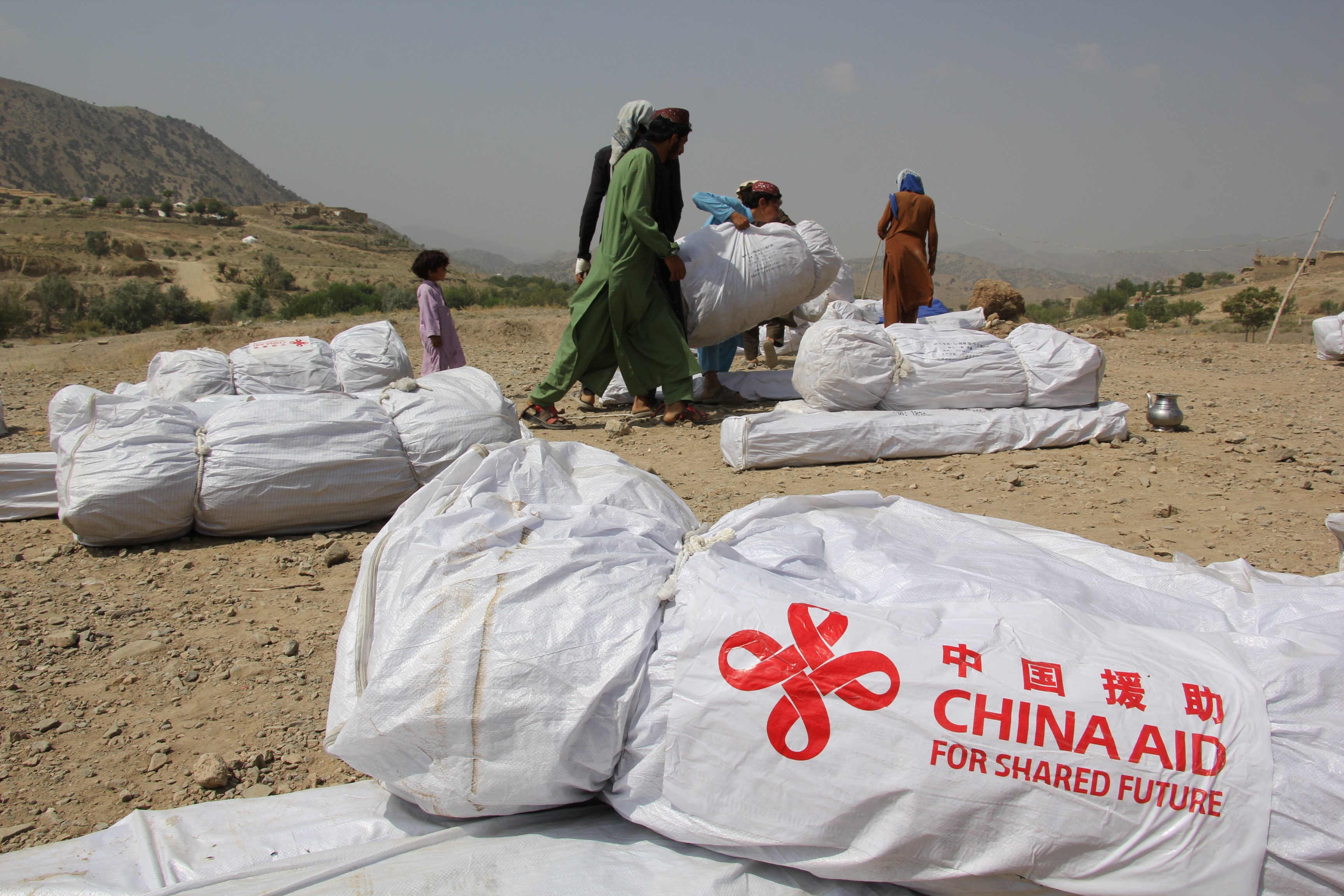 People receive relief supplies donated by China in Afghanistan’s disaster-hit Paktika province on July 2. Photo: Xinhua