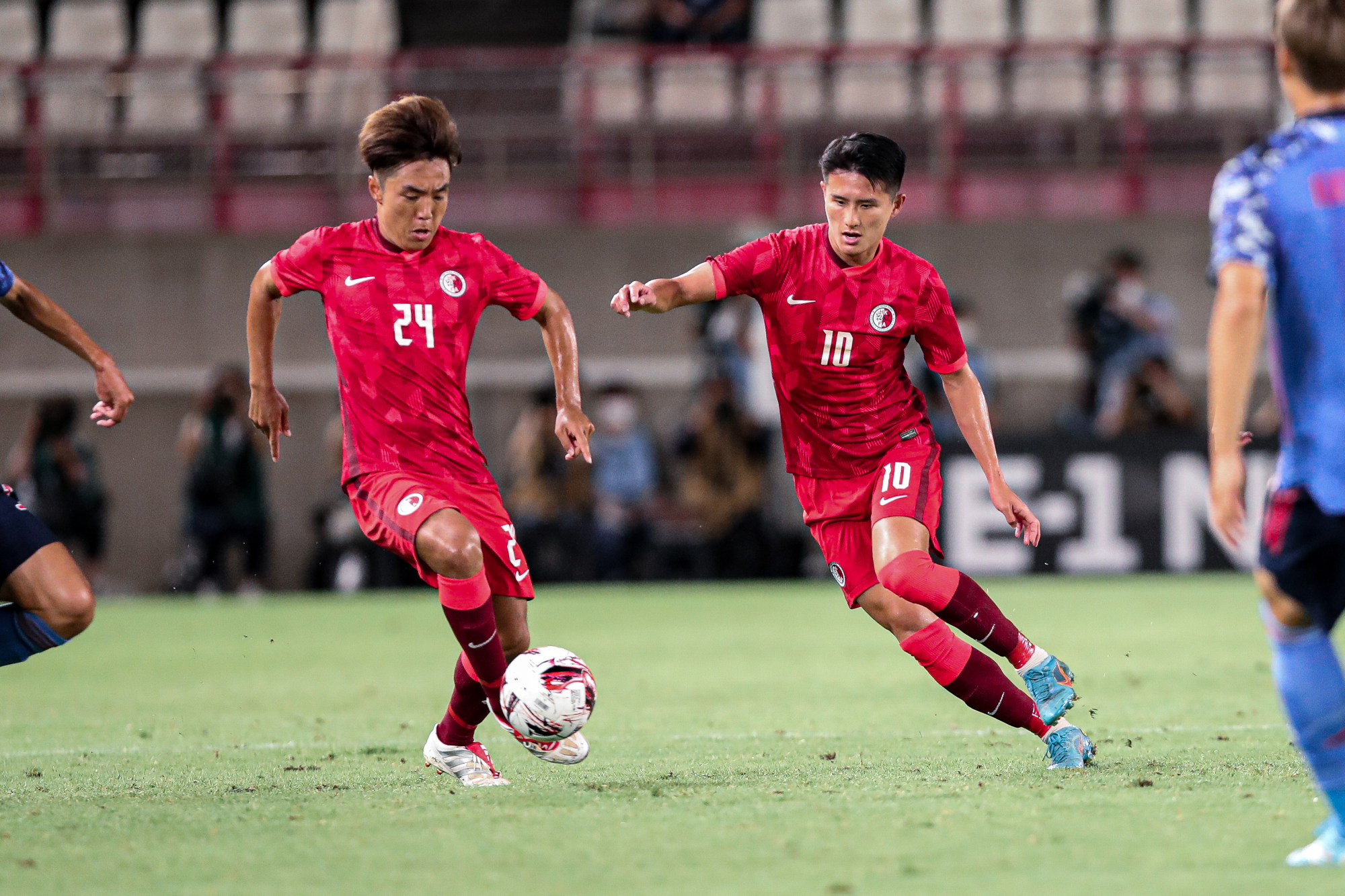 Midfielders Ju Yingzhi (no 24) and Wong Wai in the match against Japan. Photo: HKFA