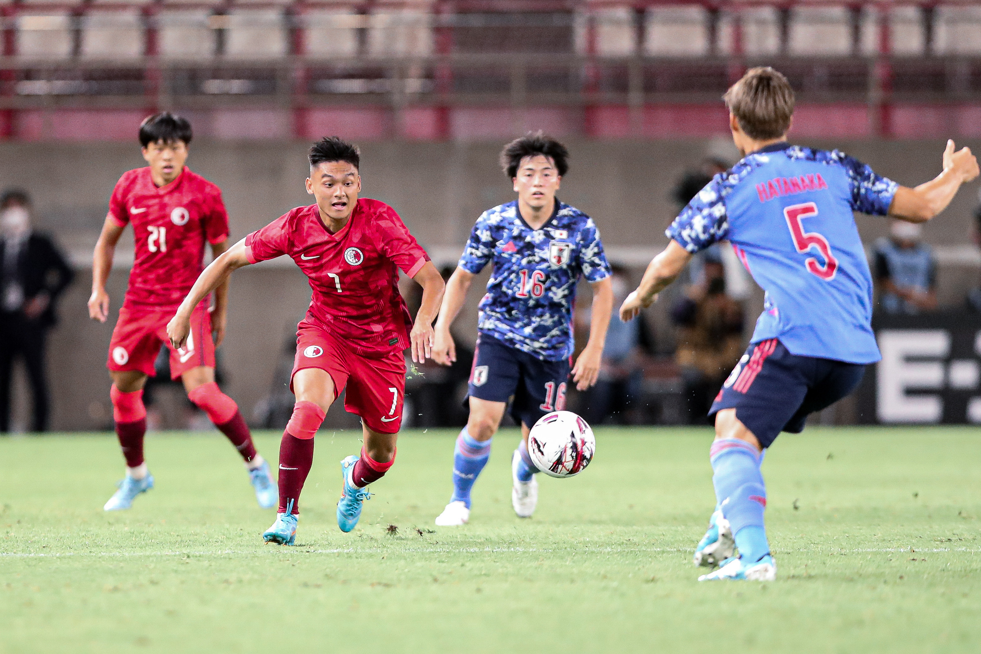 Law Tsz-chun chases the ball against Yuki Soma of Japan. Photo: HKFA 