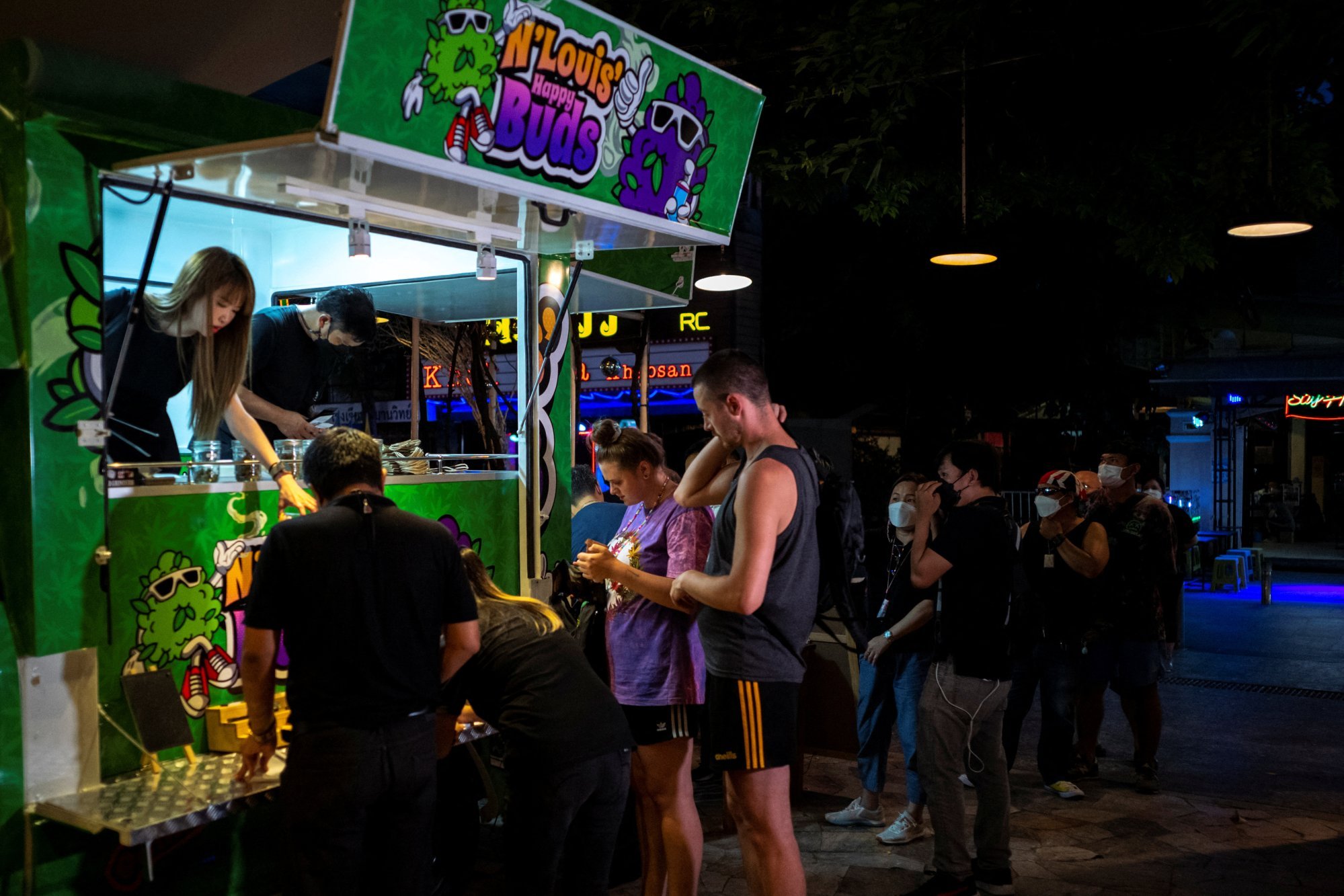 Tourists queue up to buy cannabis at a cannabis truck in Bangkok. Photo: Reuters